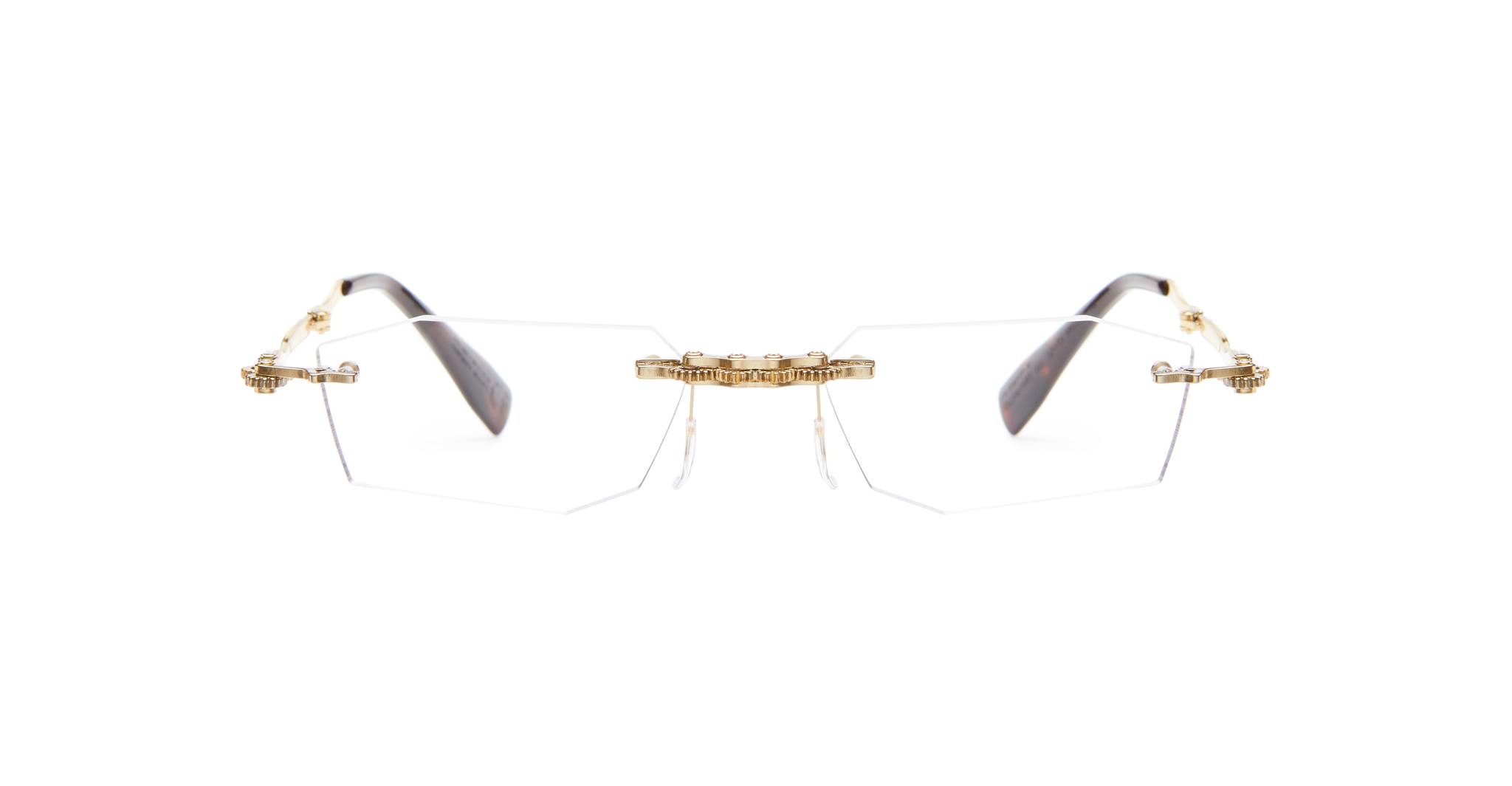 The Kuboraum H40 features rimless geometric hexagonal lenses, a gold bridge and temples, plus dark temple tips, displayed against a white background.