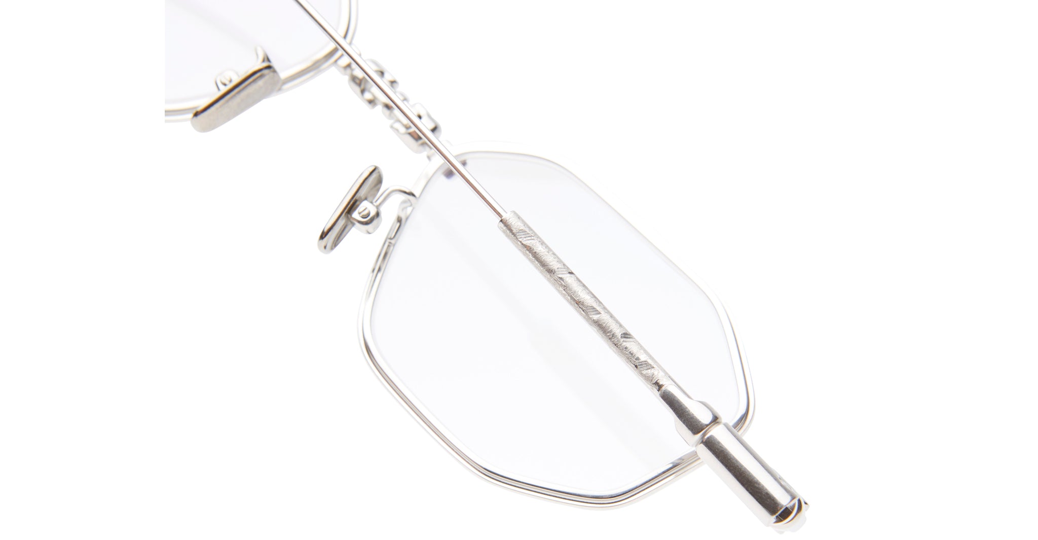Close-up of KUBORAUM Kuboraum H66 silver metal eyeglasses, showing nose pads and temple arm from a side angle.