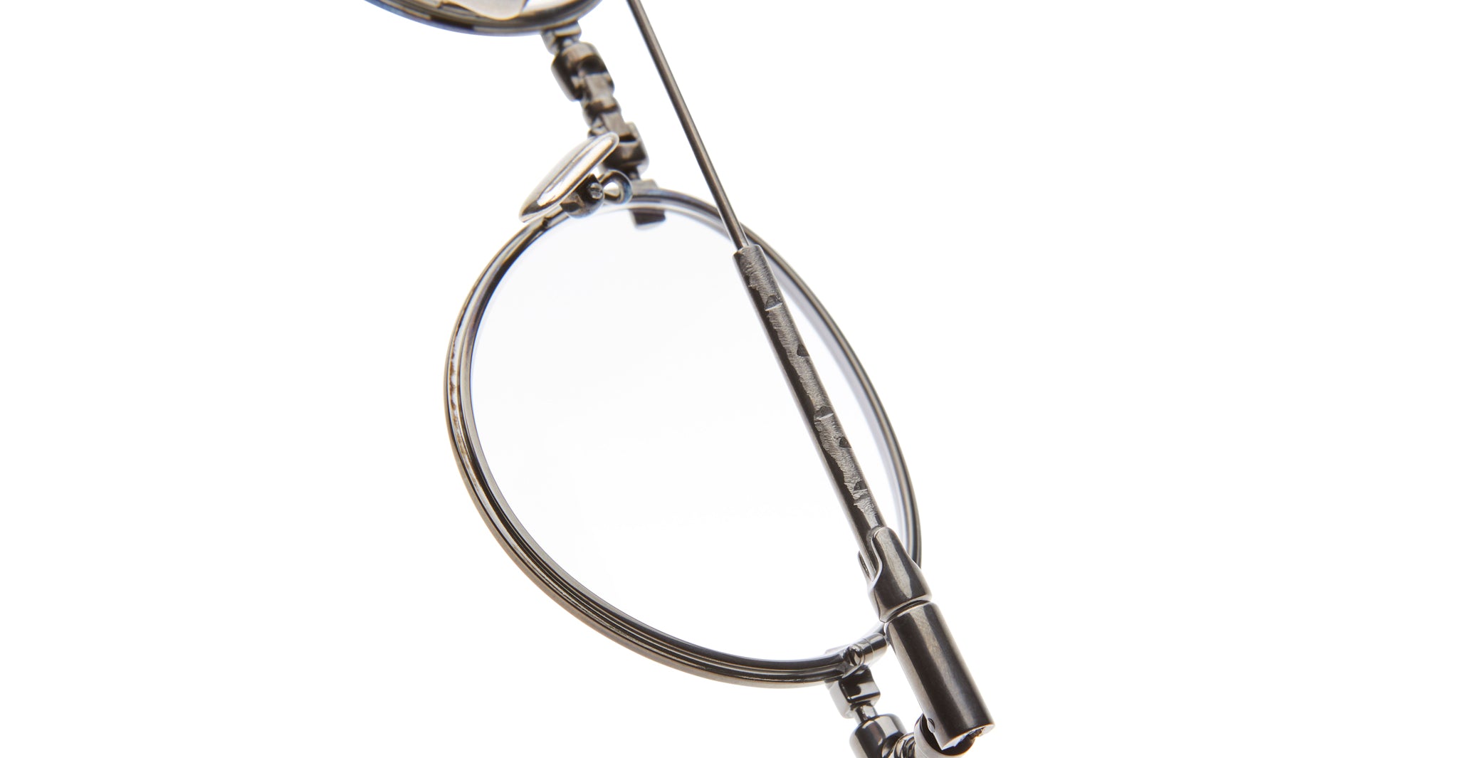 Close-up of KUBORAUM H67 eyeglasses with vintage metal rim and handle, showing front angle and brand details.