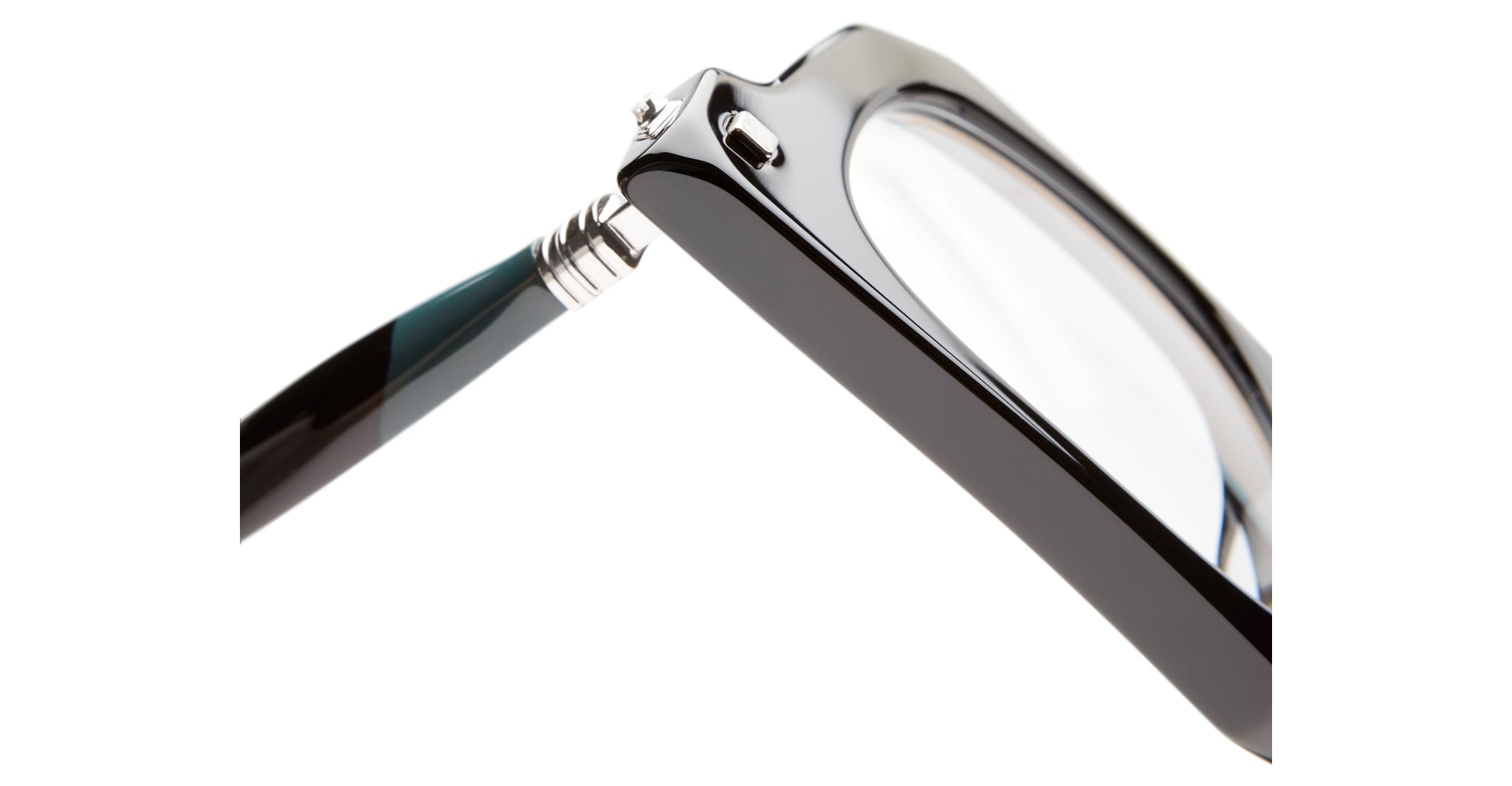 Close-up view of the corner of Kuboraum J3 black eyeglasses, focusing on the hinge where the arm meets the frame, with clear lenses against a white background.