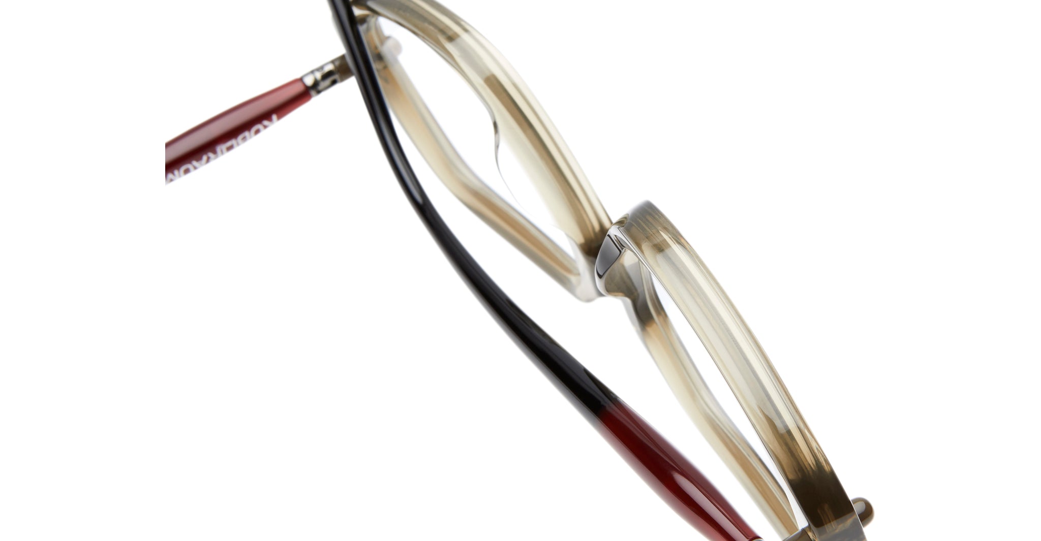 A close-up of the Kuboraum P20 eyeglasses featuring translucent beige frames and two-tone temples—one black and red, the other solid red—shown against a white background.