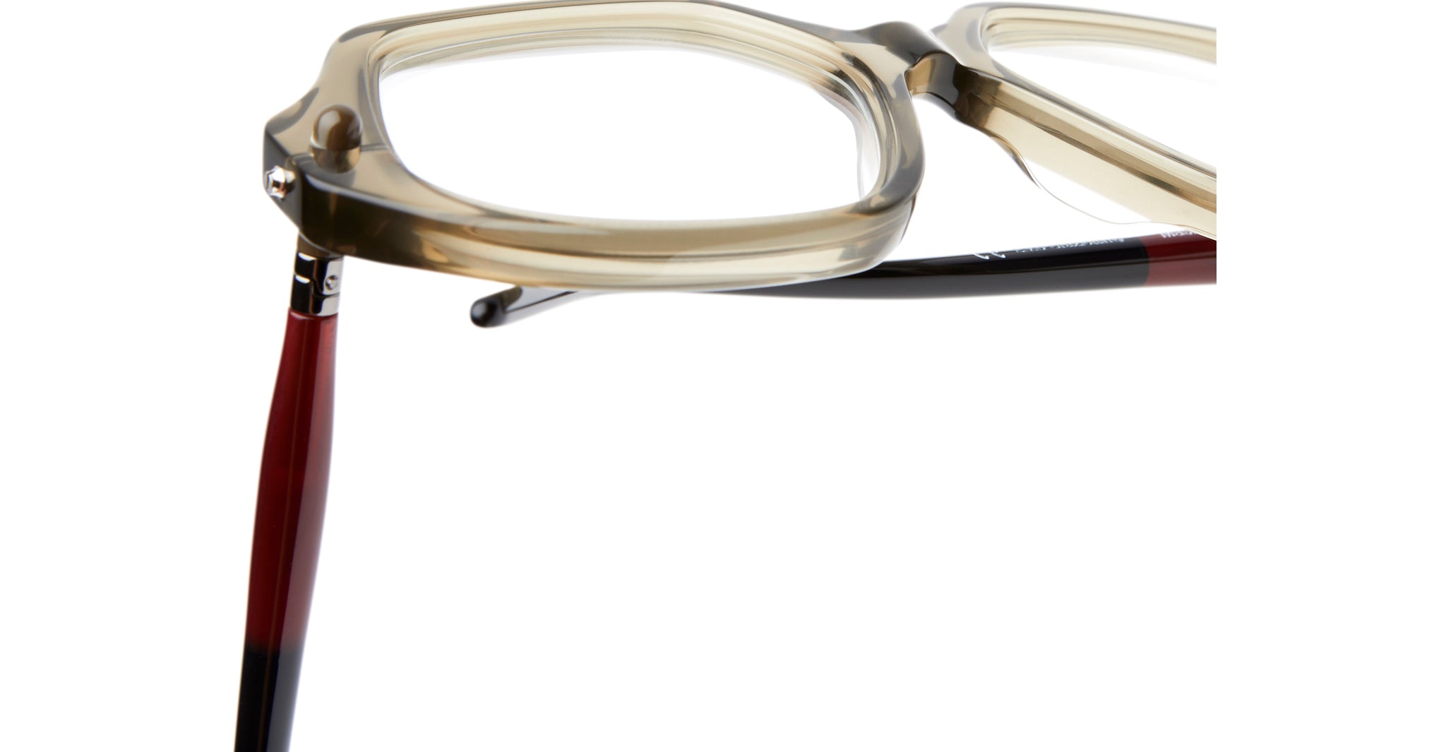 Close-up of Kuboraum P20 beige square eyeglass frames with thick rims, highlighting the corner hinge and one red and black temple arm extending outward.