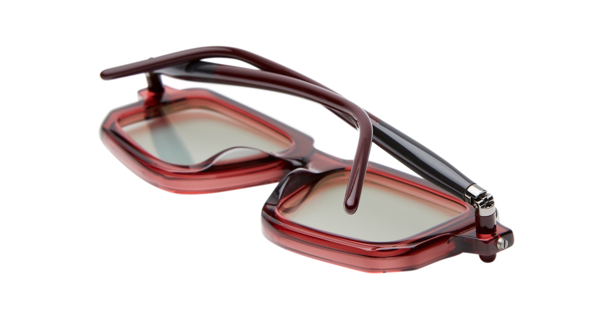 The Kuboraum P23 eyeglasses, with bold red thick rectangular frames and tinted lenses, are folded to display both the front and arms on a white background.