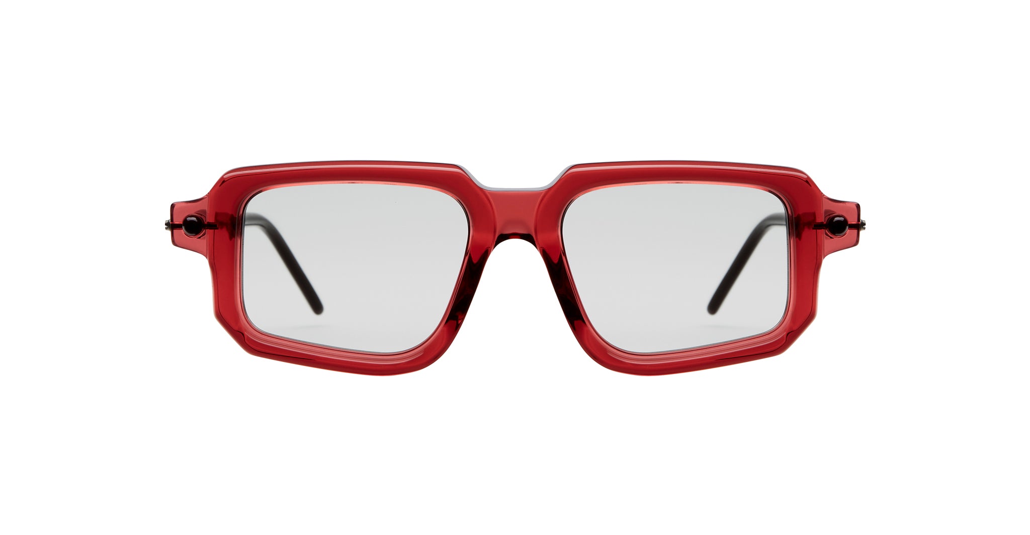 Kuboraum P23 bold square eyeglasses feature translucent red frames and clear lenses, seen from the front. The black temples are partially visible.