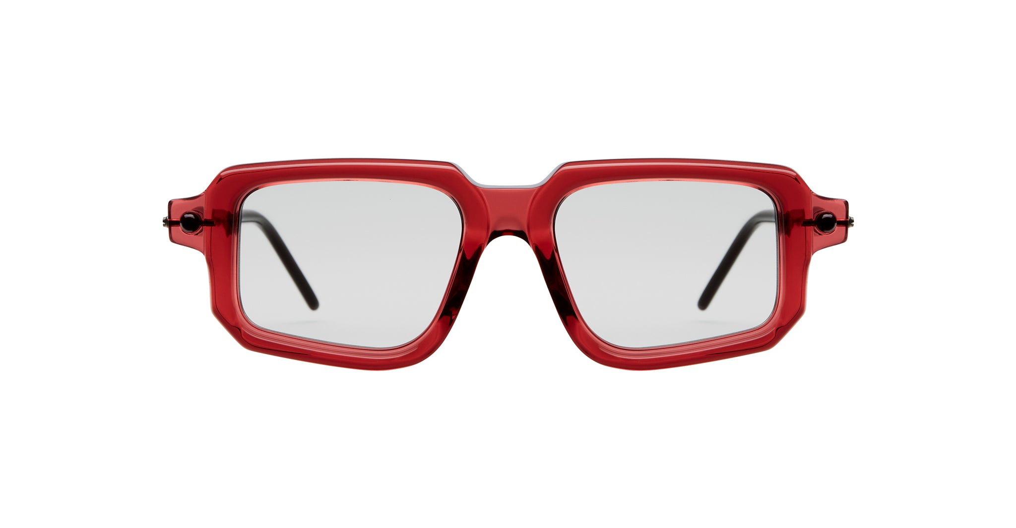 Kuboraum P23 bold square eyeglasses feature translucent red frames and clear lenses, seen from the front. The black temples are partially visible.