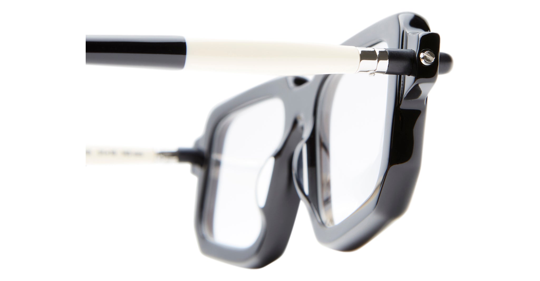 Close-up view of Kuboraum P23 black and white eyeglasses with clear lenses, highlighting the detailed frame and arm design against a white background.