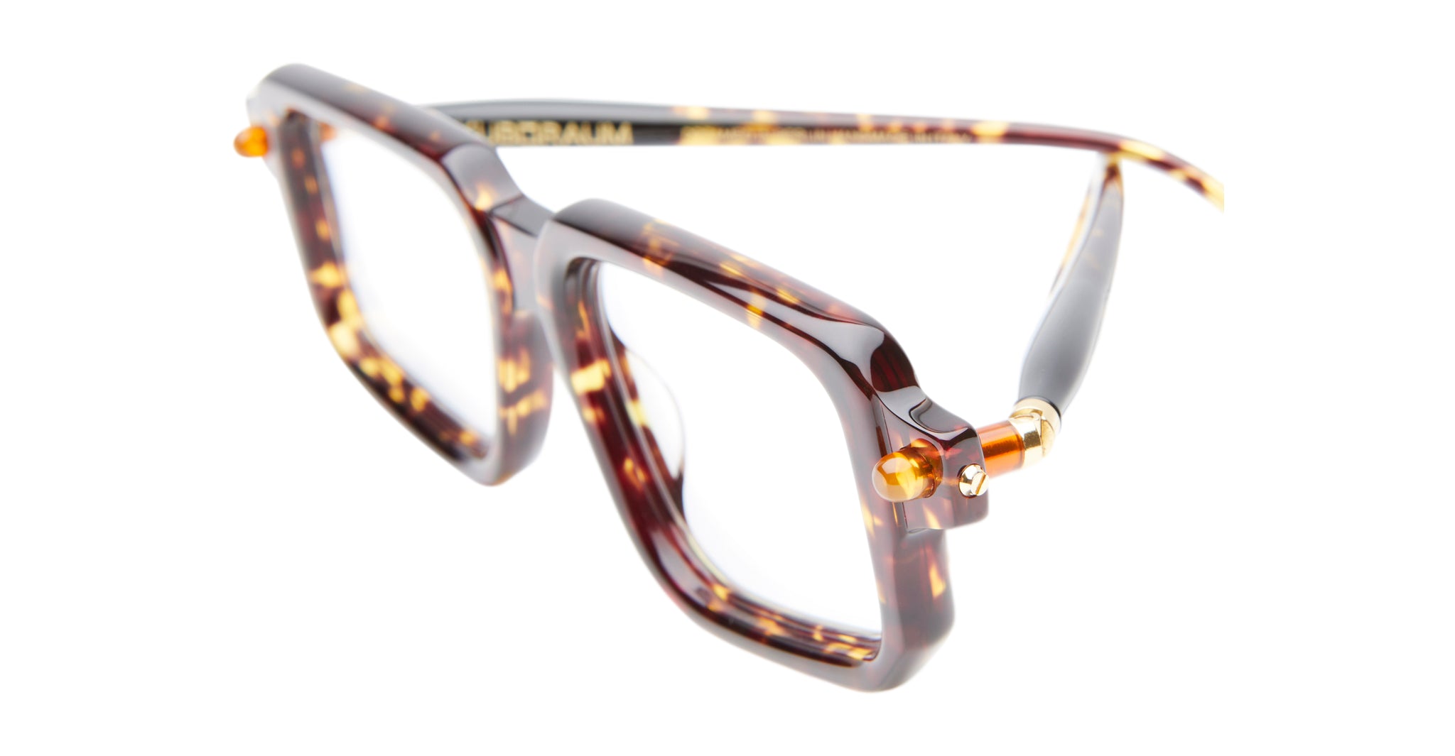 Kuboraum P23 oversized square eyeglasses, featuring a tortoiseshell pattern, transparent lenses, and gold hinge accents, displayed on a white background.