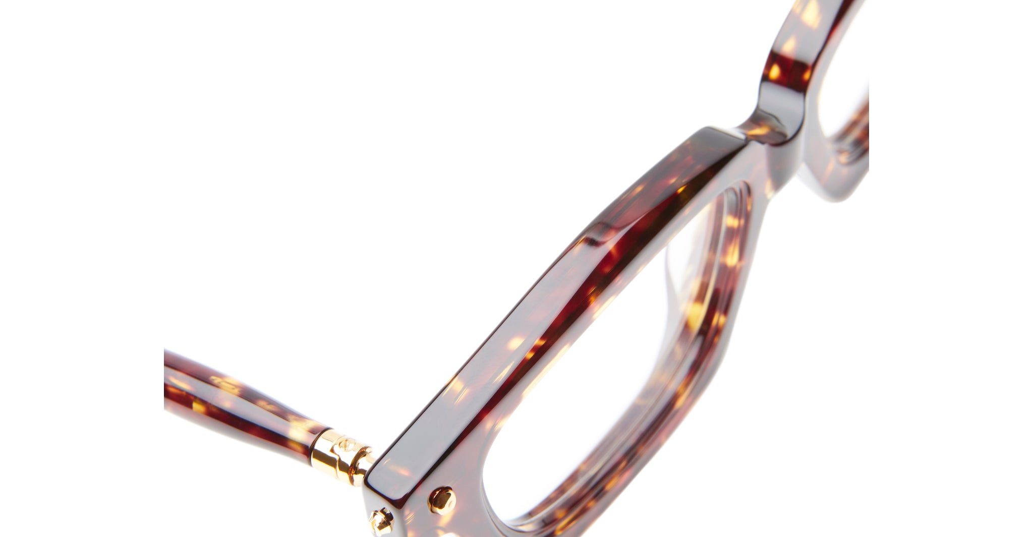 Close-up of the corner of Kuboraum P25 eyeglasses featuring a brown tortoiseshell frame and gold hinge, set against a white background.