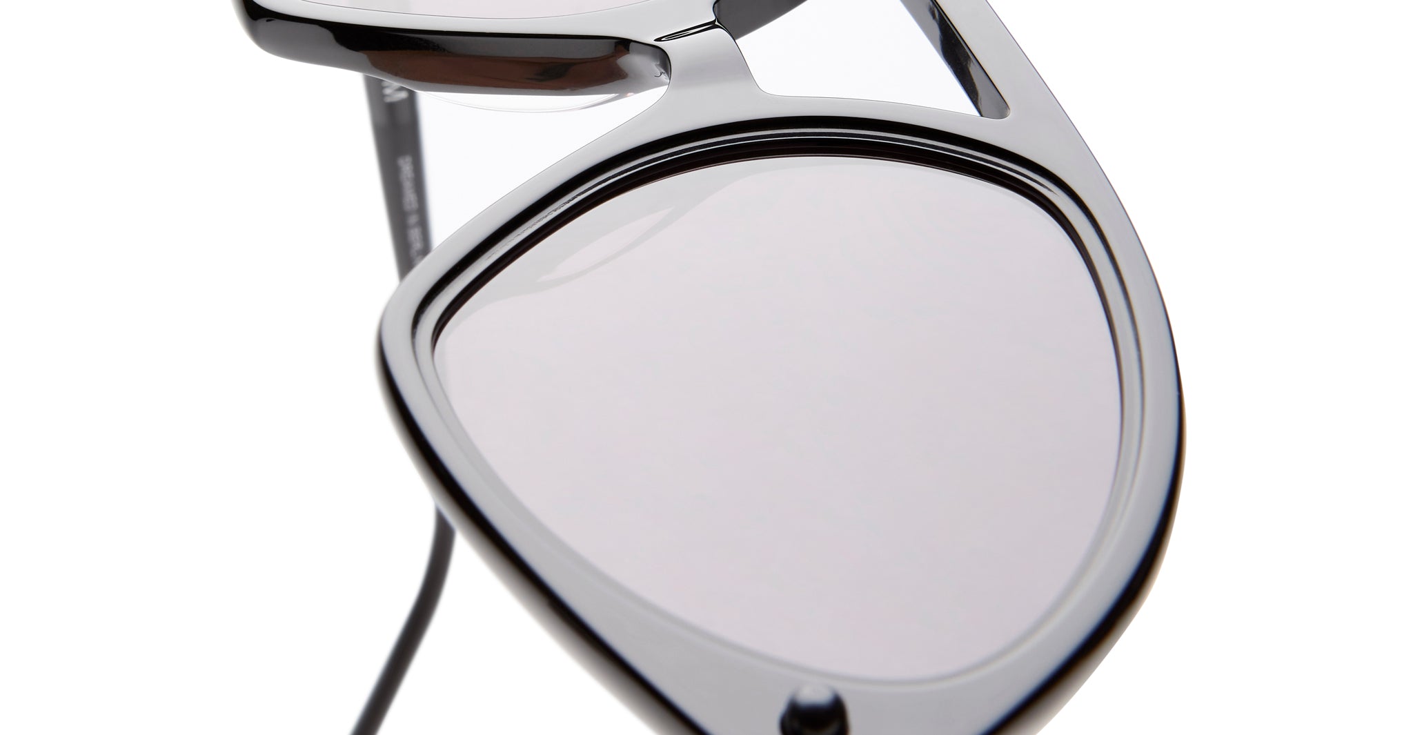 Close-up of KUBORAUM P31 sunglasses, angular lenses, glossy black acetate frame, front angle view.