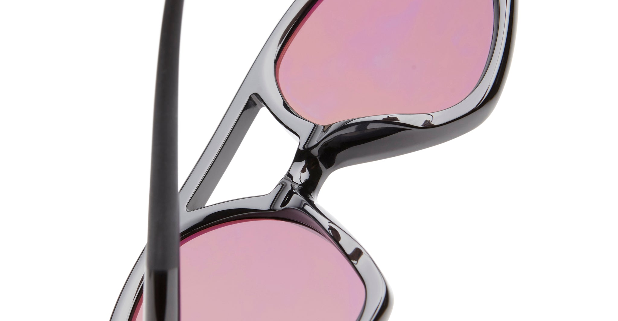 Close-up of KUBORAUM P31 black sunglasses frames with pink lenses, partially folded, showing the modern eyewear design.