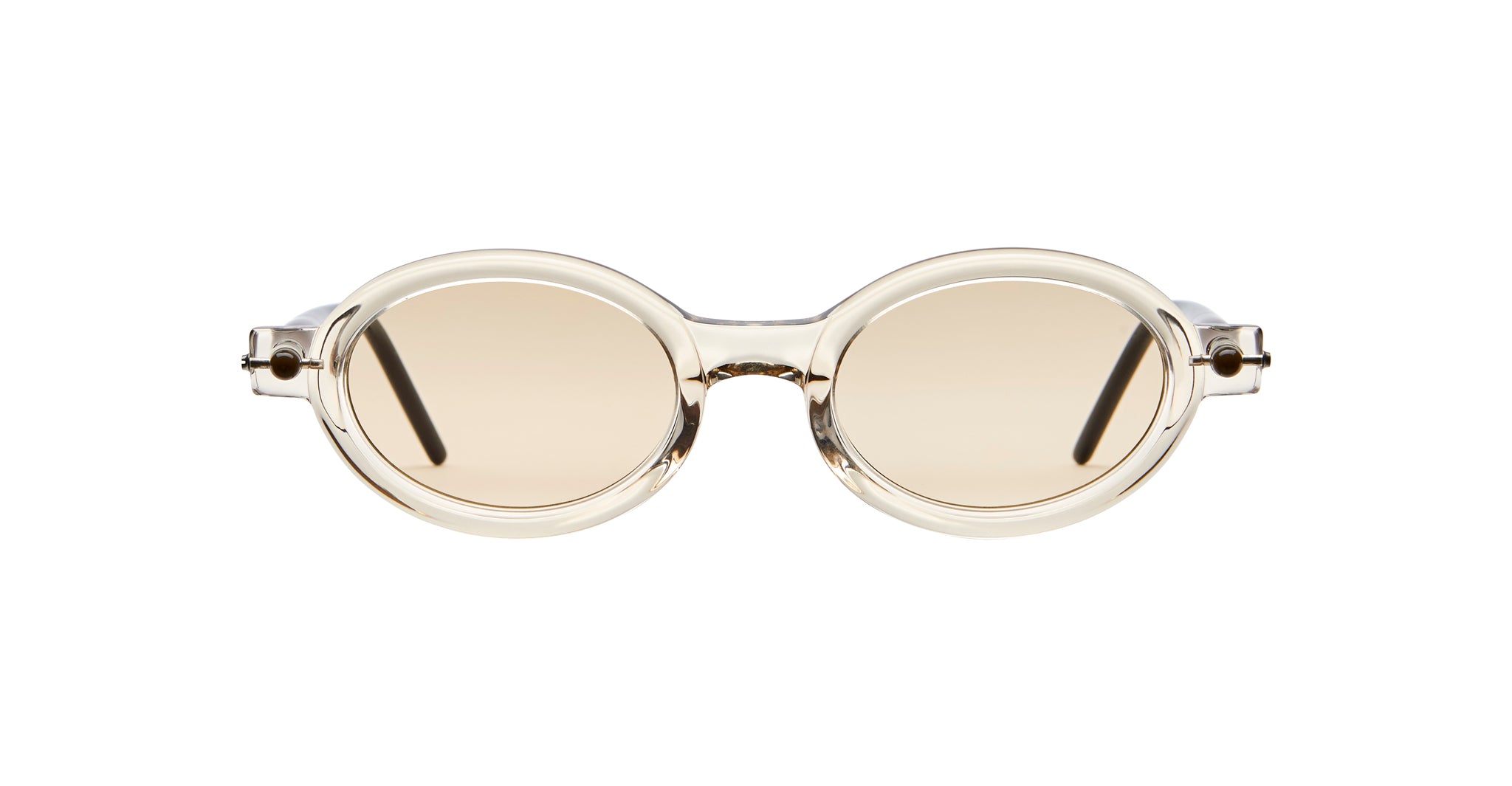 The Kuboraum P6 sunglasses feature round, beige-tinted lenses with clear, thick frames and dark temple arms, showcased on a white background.