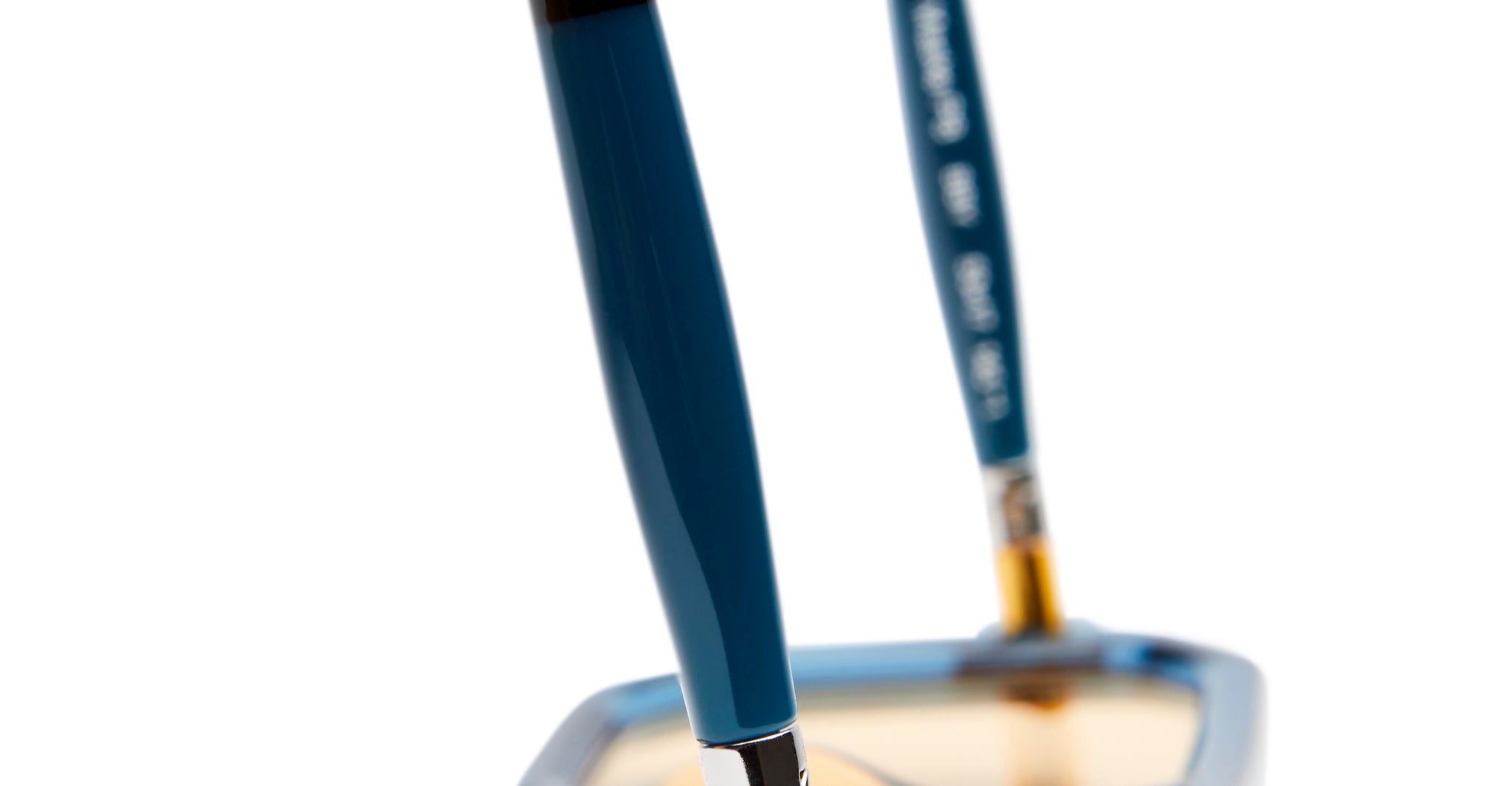 Close-up of the blue arms and upper frame of Kuboraum P8 eyeglasses, focusing on the temples against a blurred white background.