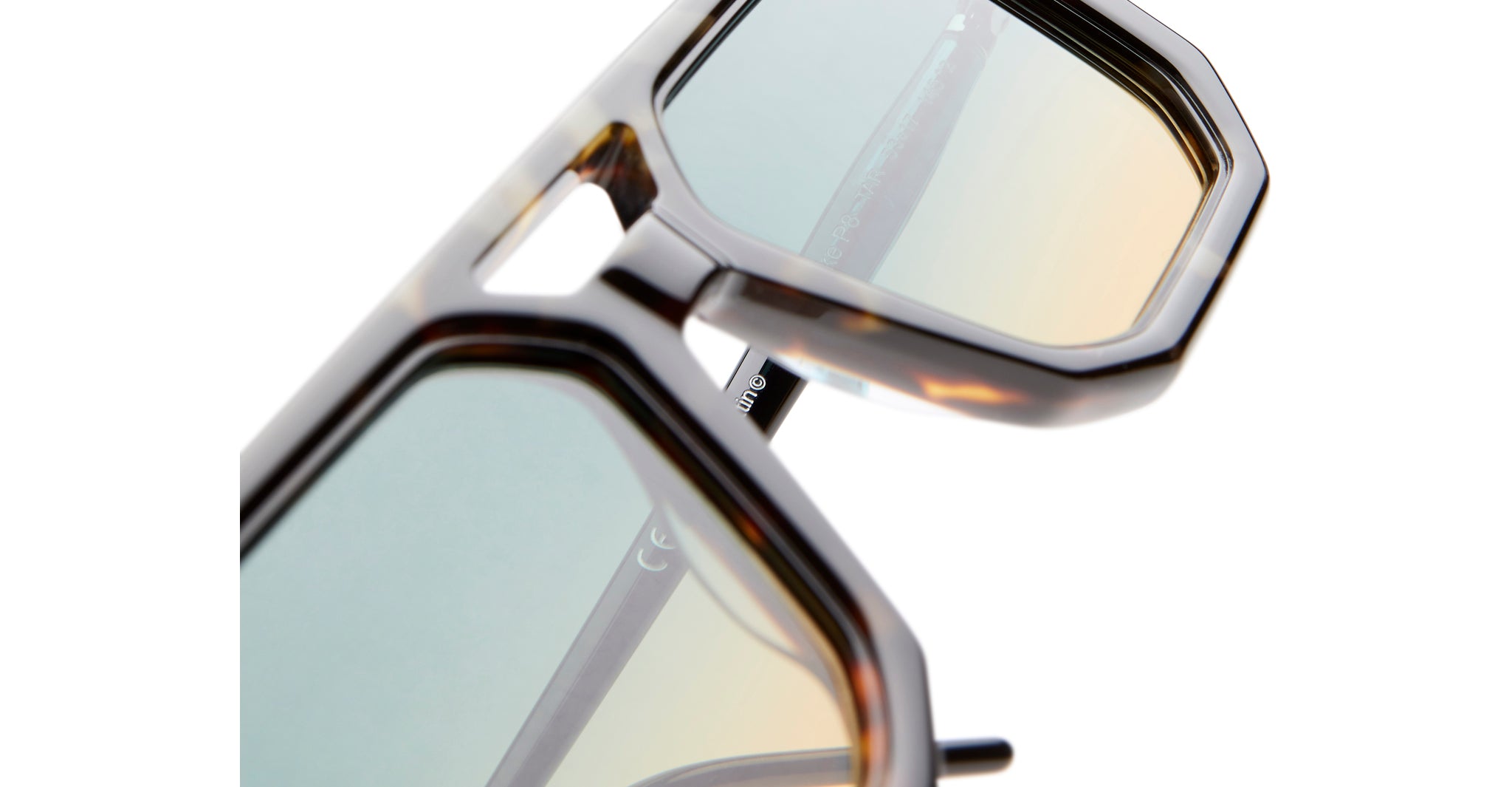 Close-up of KUBORAUM P8 geometric sunglasses with tortoiseshell frame and tinted lenses.