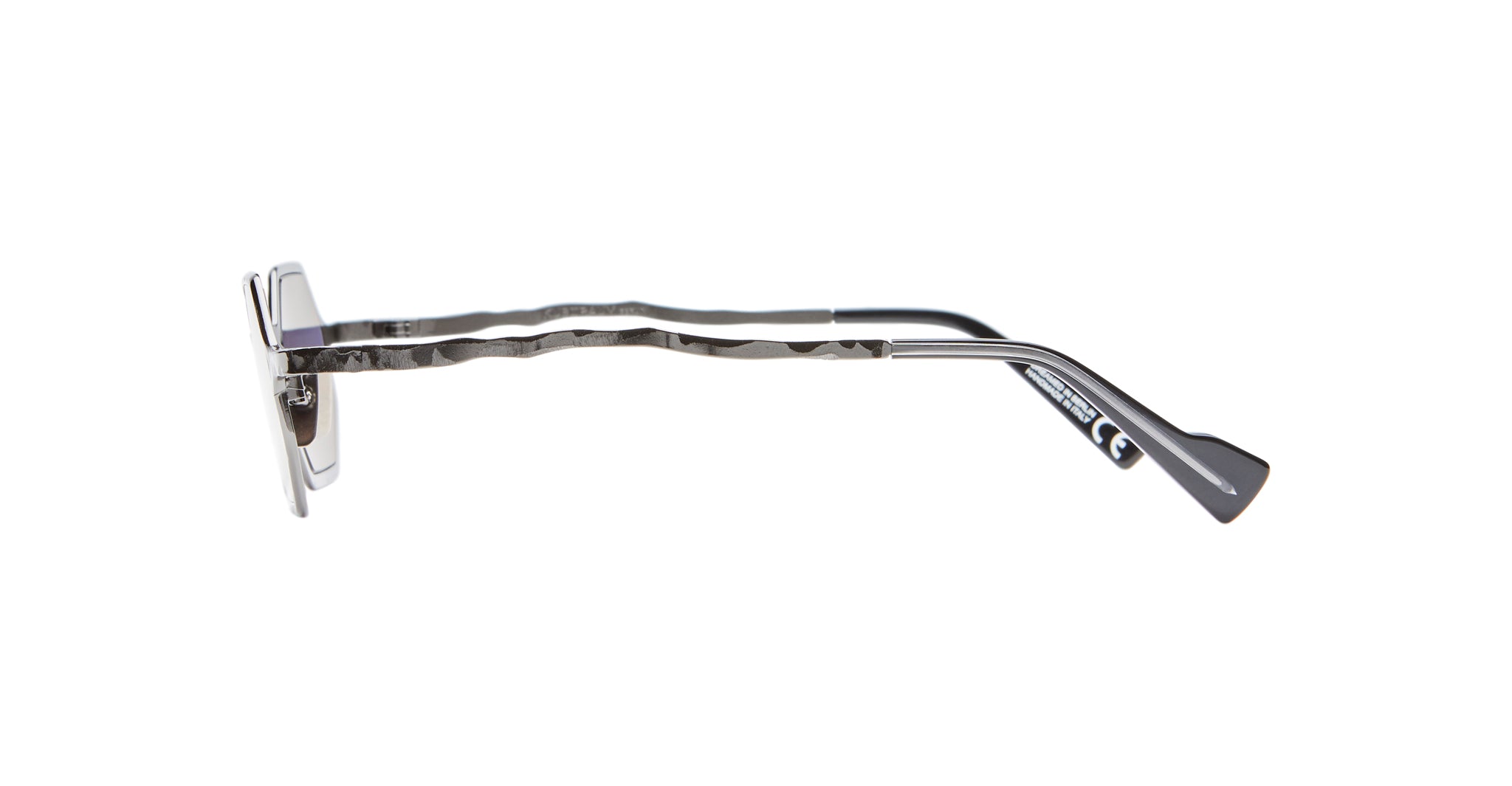 Side view of Kuboraum Z19 rectangular sunglasses with silver, wavy metal arms and black temple tips against a white background.