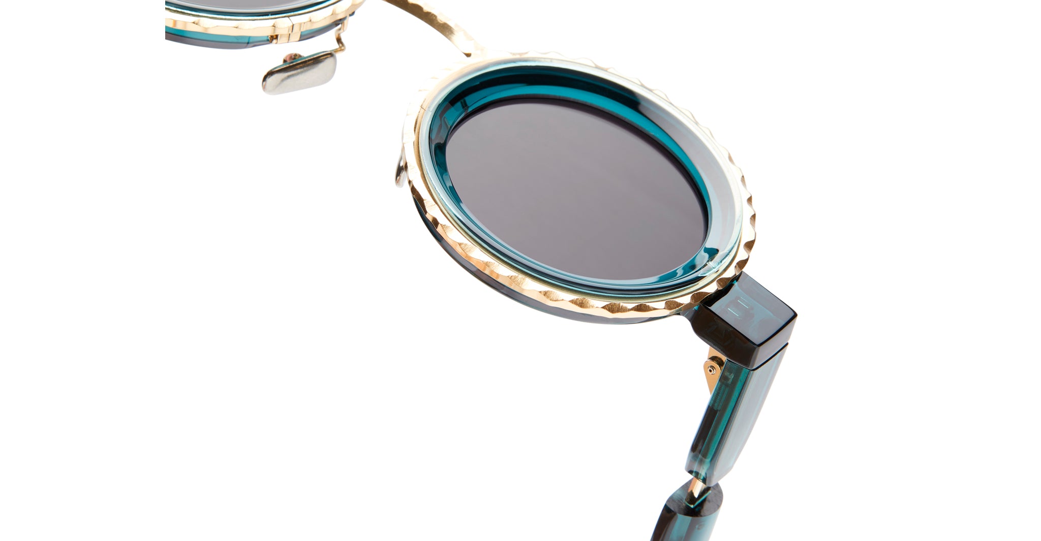 Close-up of Kuboraum Z3 round sunglasses with teal frames, gold details, and dark lenses, front angle visible.