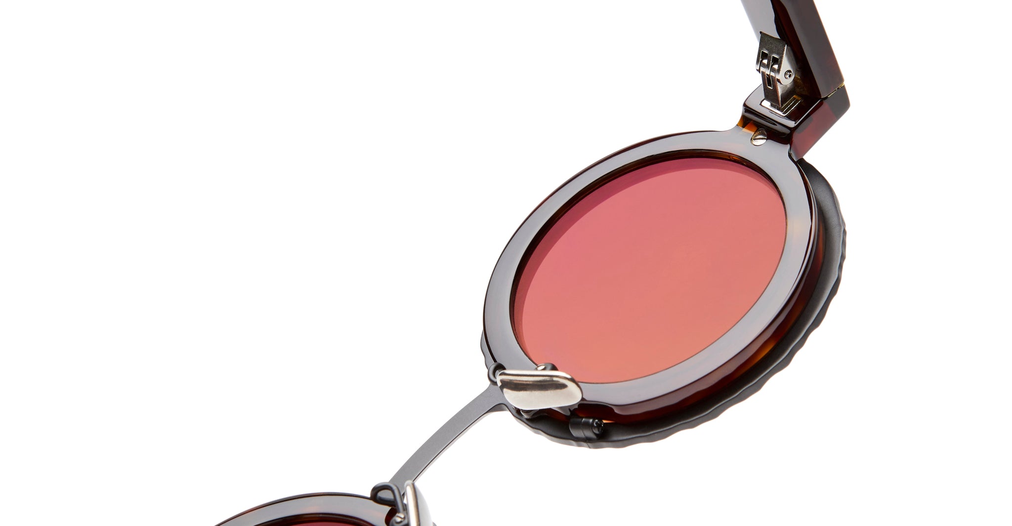 Close-up of KUBORAUM Z3 sunglasses with round brown frame and pink-tinted UV lenses, partially folded, front angle.