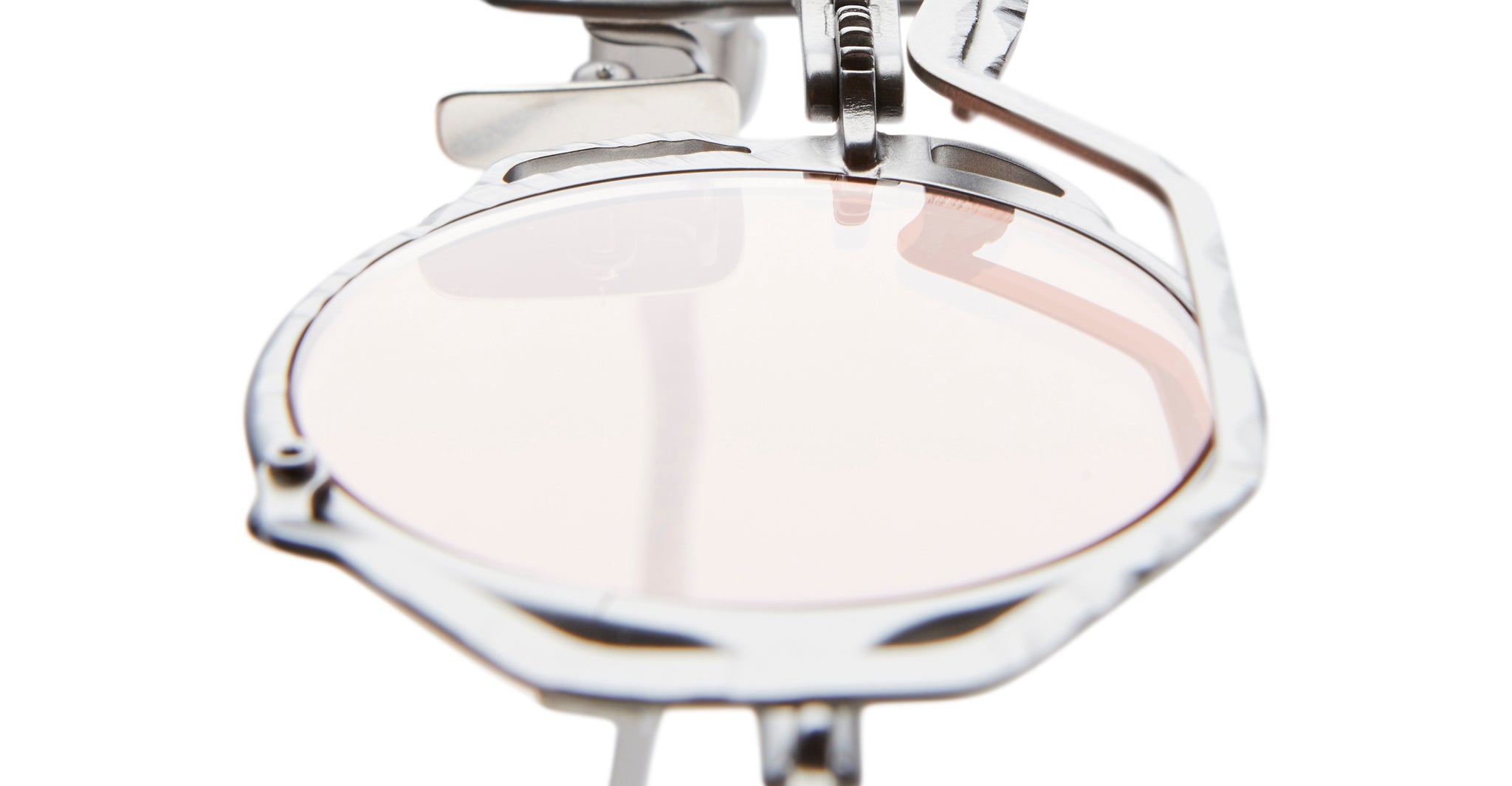 Close-up view of a single round Kuboraum Z50 lens held in a metallic optical device, likely a lens testing or fitting tool, against a white background.