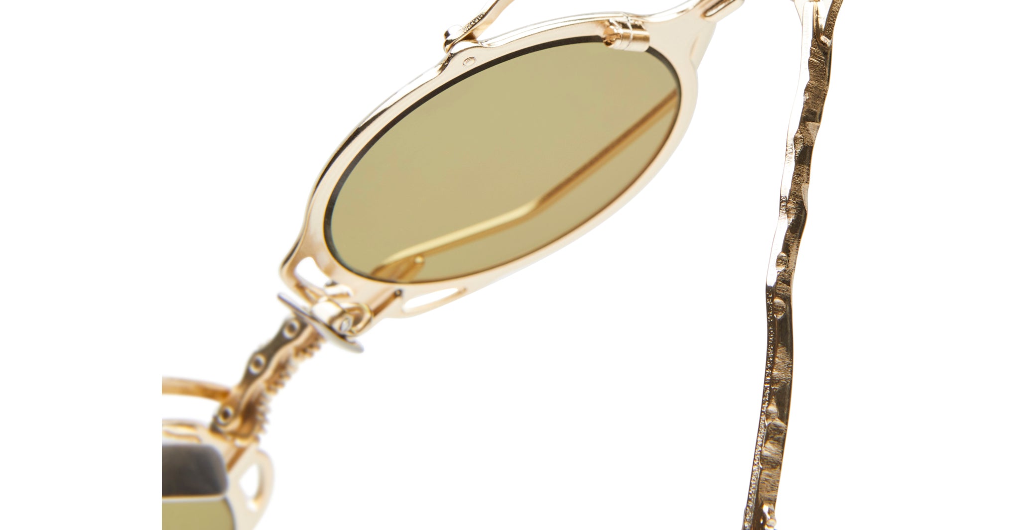 Close-up of KUBORAUM Z50 sunglasses, featuring gold oval frames, green lenses, and twisted metal temples.