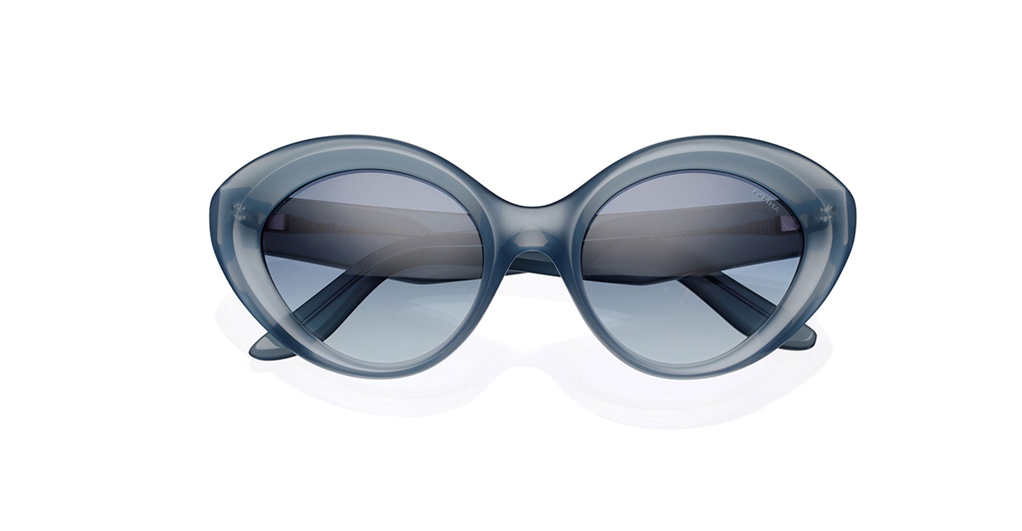 Lapima Julia sunglasses in blue feature oversized round frames, crafted from Italian acetate with dark tinted lenses. Shown front view on a white background, they make a bold statement in feminine eyewear.