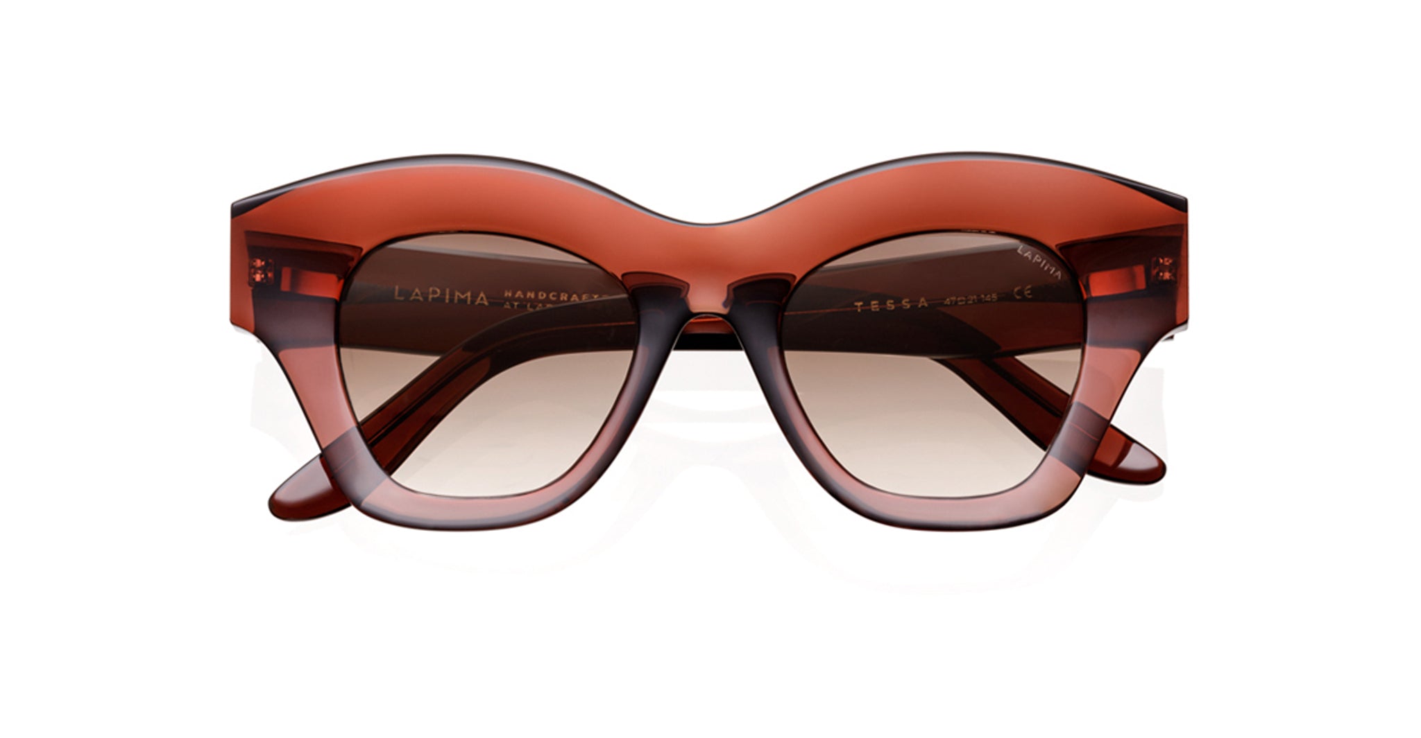 Lapima Tessa sunglasses feature bold, thick translucent brown frames with a subtle cat-eye shape. Handcrafted in Brazil from premium Italian acetate, these vintage-inspired shades offer a glossy finish and contemporary style.