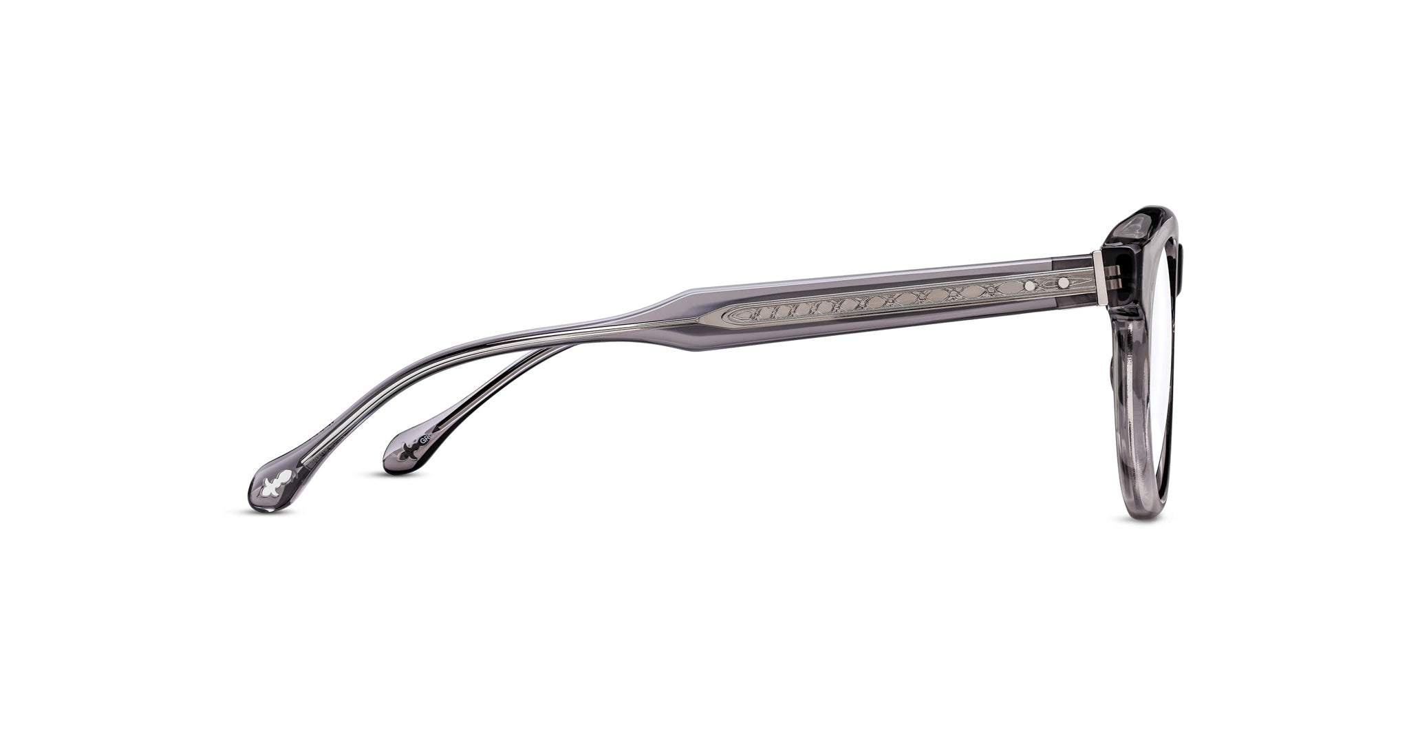 Side view of Matsuda M1036 (Copy) eyeglasses featuring transparent gray frames and decorative temple detailing, set against a white background.