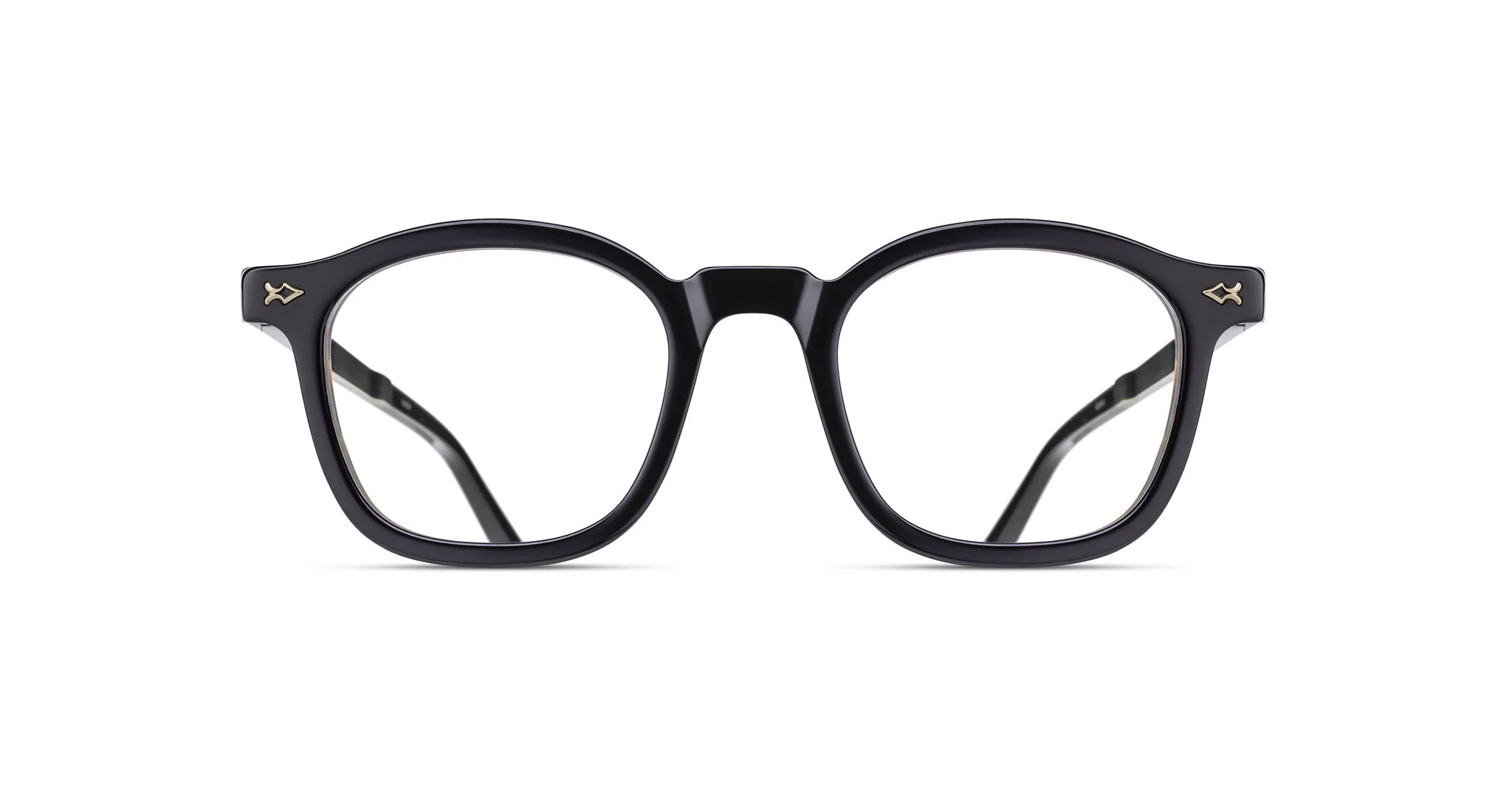 The Matsuda M2068 features black, round prescription eyeglasses with thick frames and small metallic arrow-shaped accents on the upper corners, displayed front-facing against a white background.