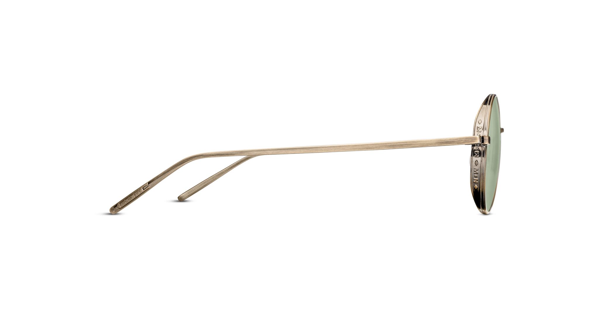 Side view of Matsuda M3087 round sunglasses featuring thin antique gold metal frames and green-tinted lenses on a white background.
