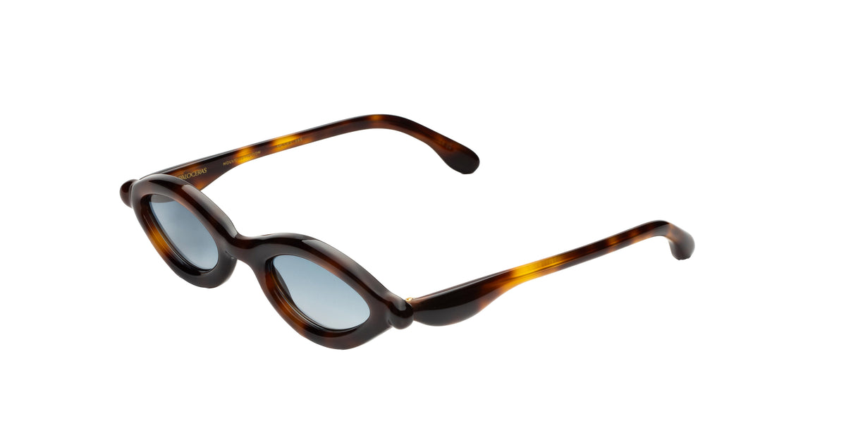 Paloceras D2 cateye sunglasses in Havana Gold, a dark tortoise frame with warm amber highlights and blue-gray lenses, angled view