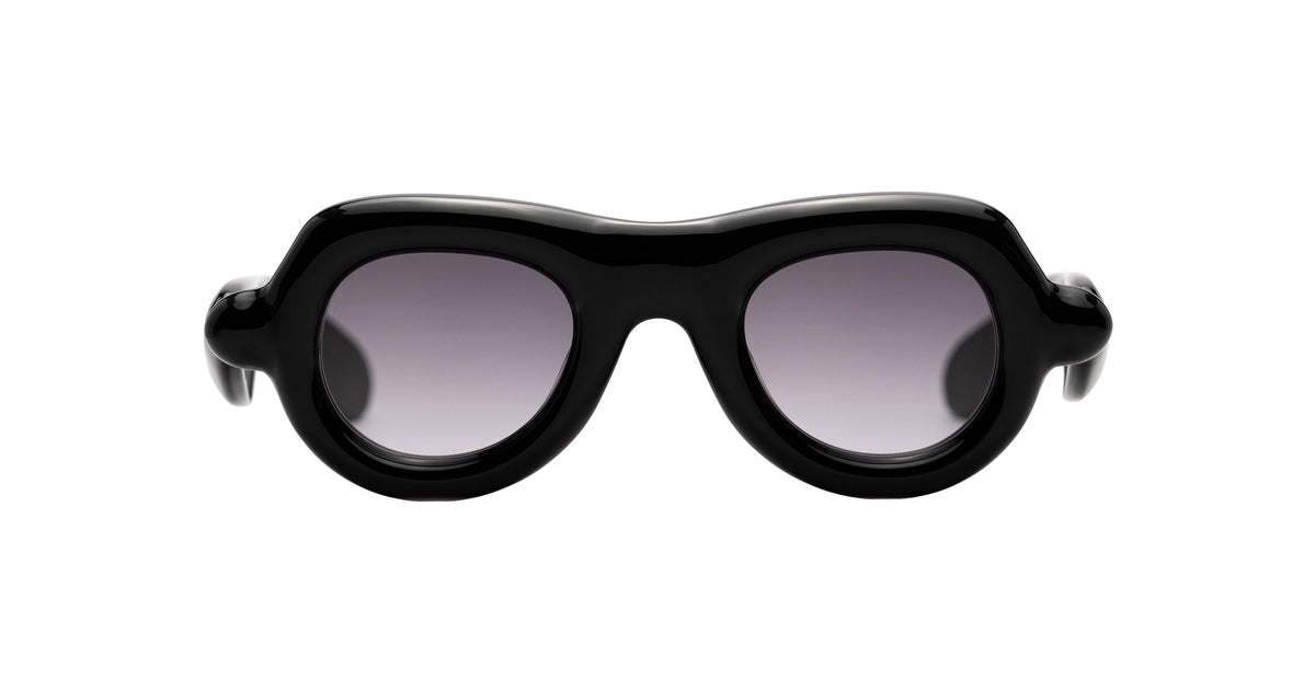 Black oversized aviator sunglasses with a thick, sculptural frame and gradient gray lenses by Paloceras