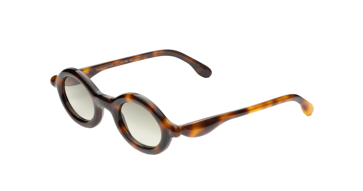 Paloceras Nouvelle Fiction R2 Havana Gold sunglasses in a dark brown tortoiseshell frame with warm amber highlights, rounded oval rims, and pale green lenses, three-quarter view