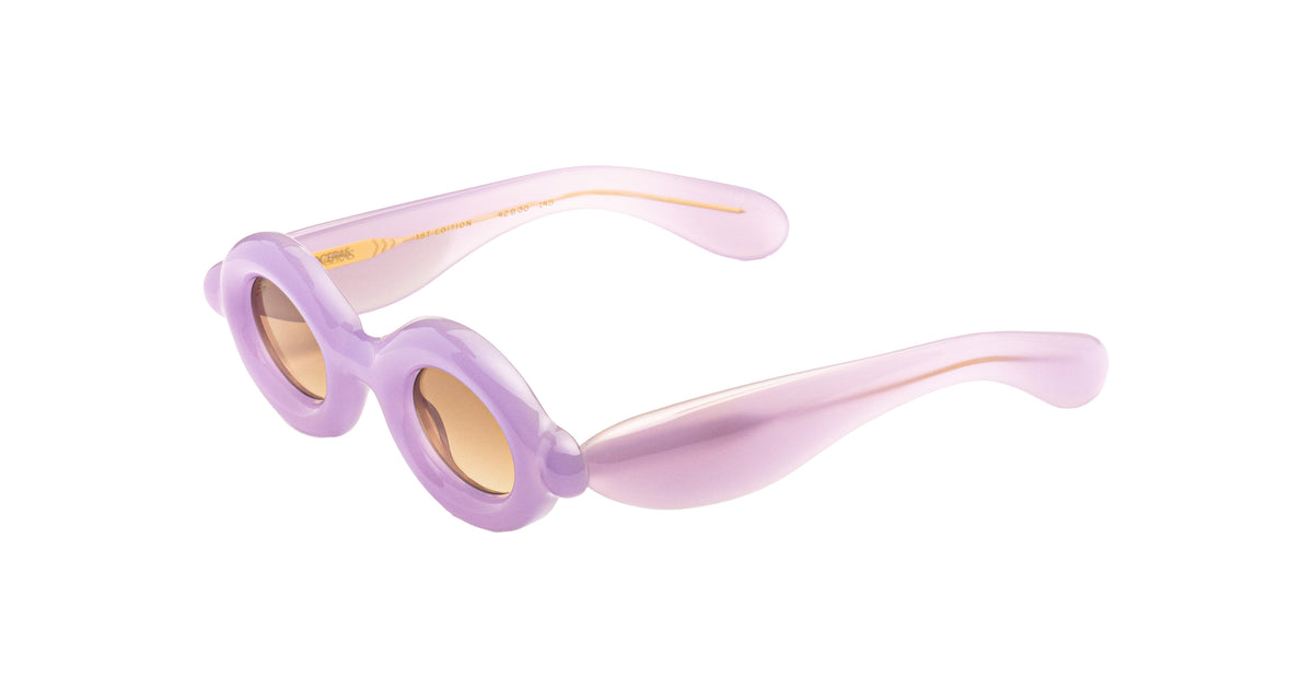 Paloceras Pebble RX Lilac Dream sunglasses with thick rounded rims and warm brown lenses, angled view