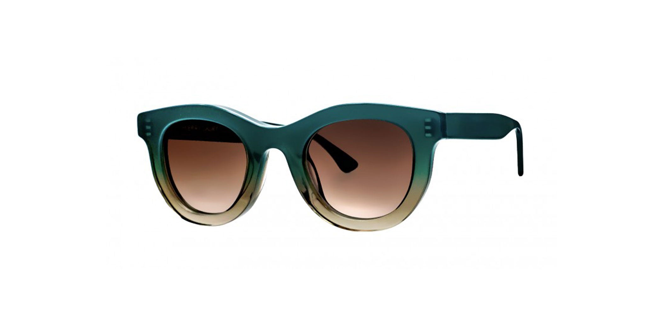 The Thierry Lasry Consistency features oversized, round green frames and brown gradient lenses, displayed from the front against a plain white background.