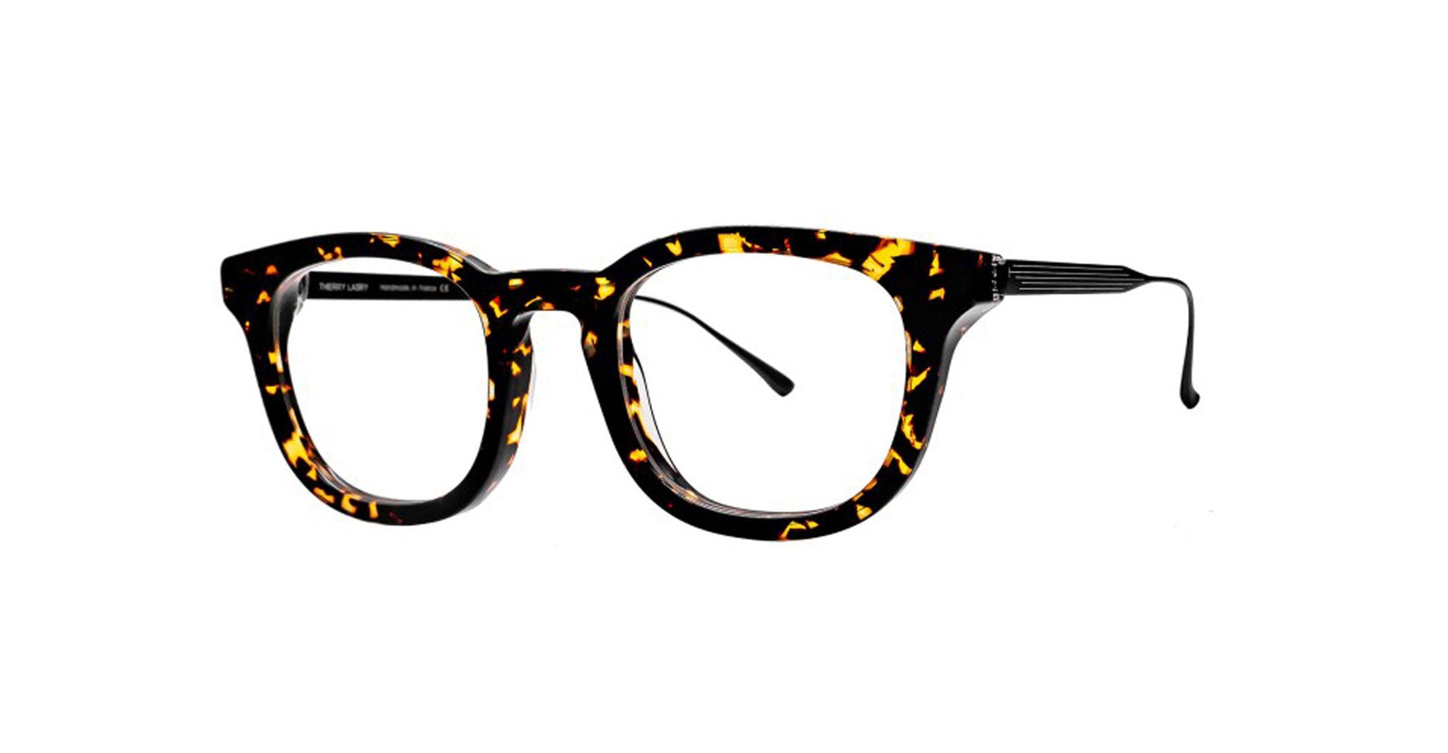 The Thierry Lasry Frenety eyeglasses feature round rectangular lenses and a black-and-brown tortoiseshell frame with thin, outward-curving temples, set against a plain white background.