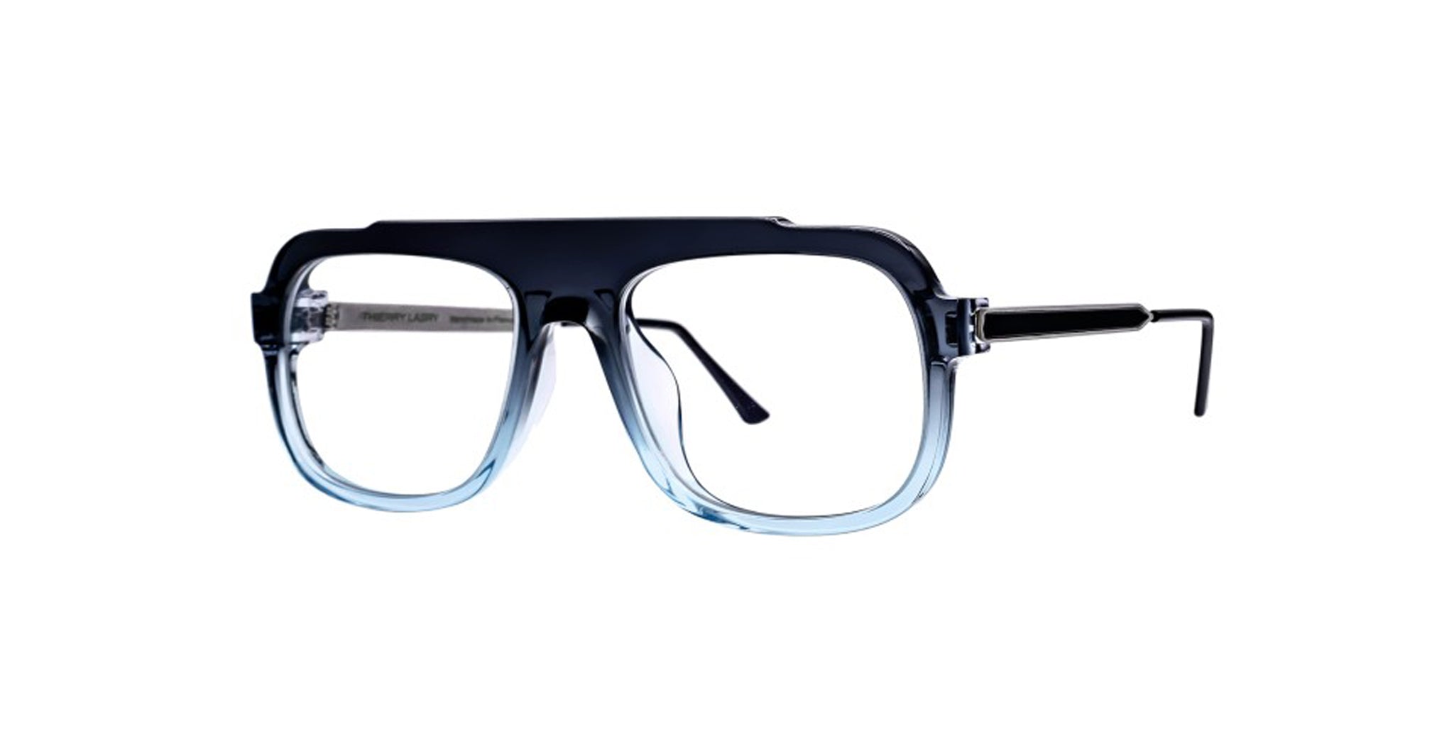 Thierry Lasry Poisony: Oversized rectangular eyeglasses with a thick black-to-clear gradient frame and metal temples, shown on a white background.