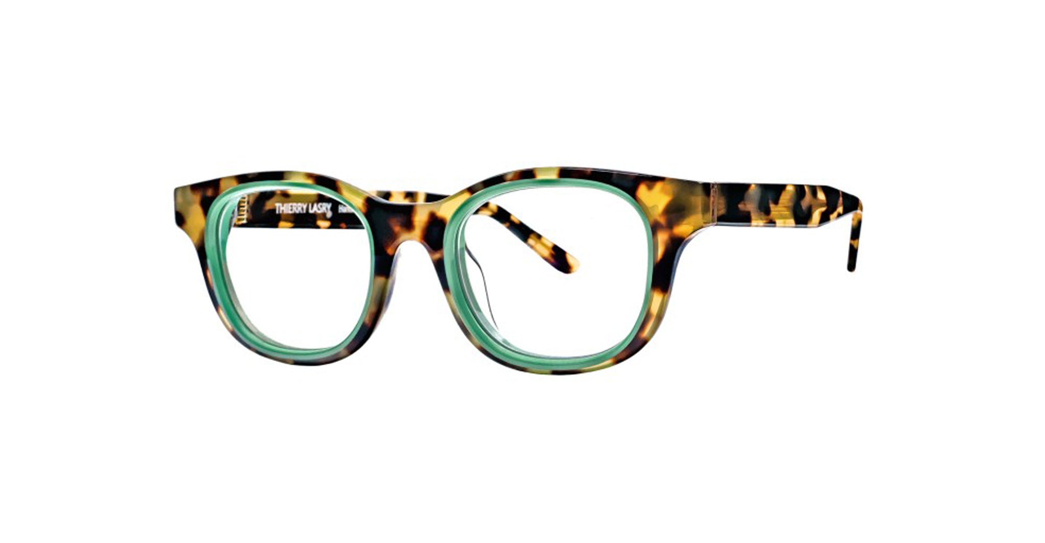 Thierry Lasry Tyranny eyeglasses feature round lenses and a thick, multicolored tortoiseshell frame with a light green inner rim. The inside left temple is inscribed with THIERRY LASRY.