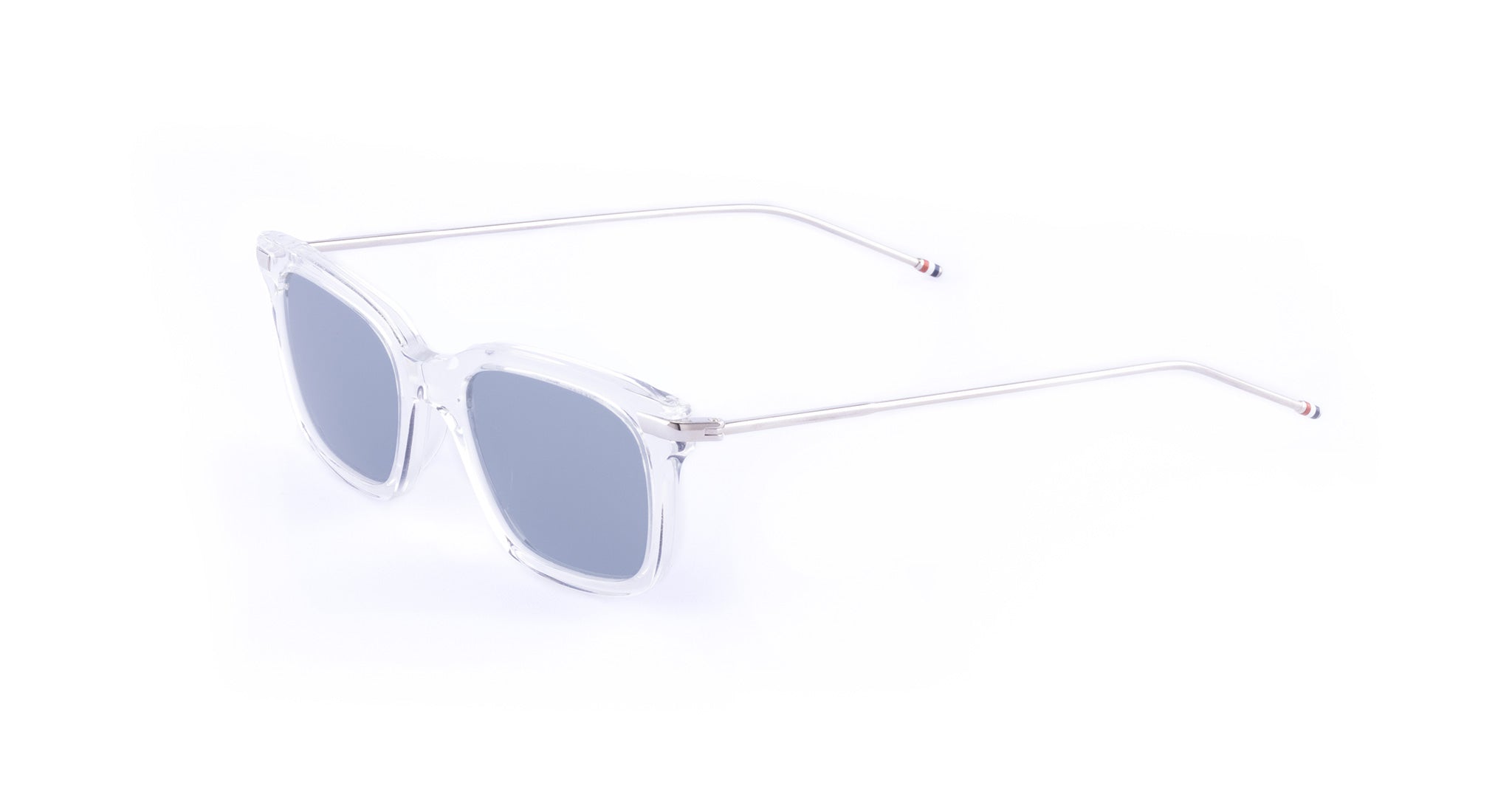Thom Browne 701 sunglasses with square blue lenses, clear frames, thin silver arms; front and side view.