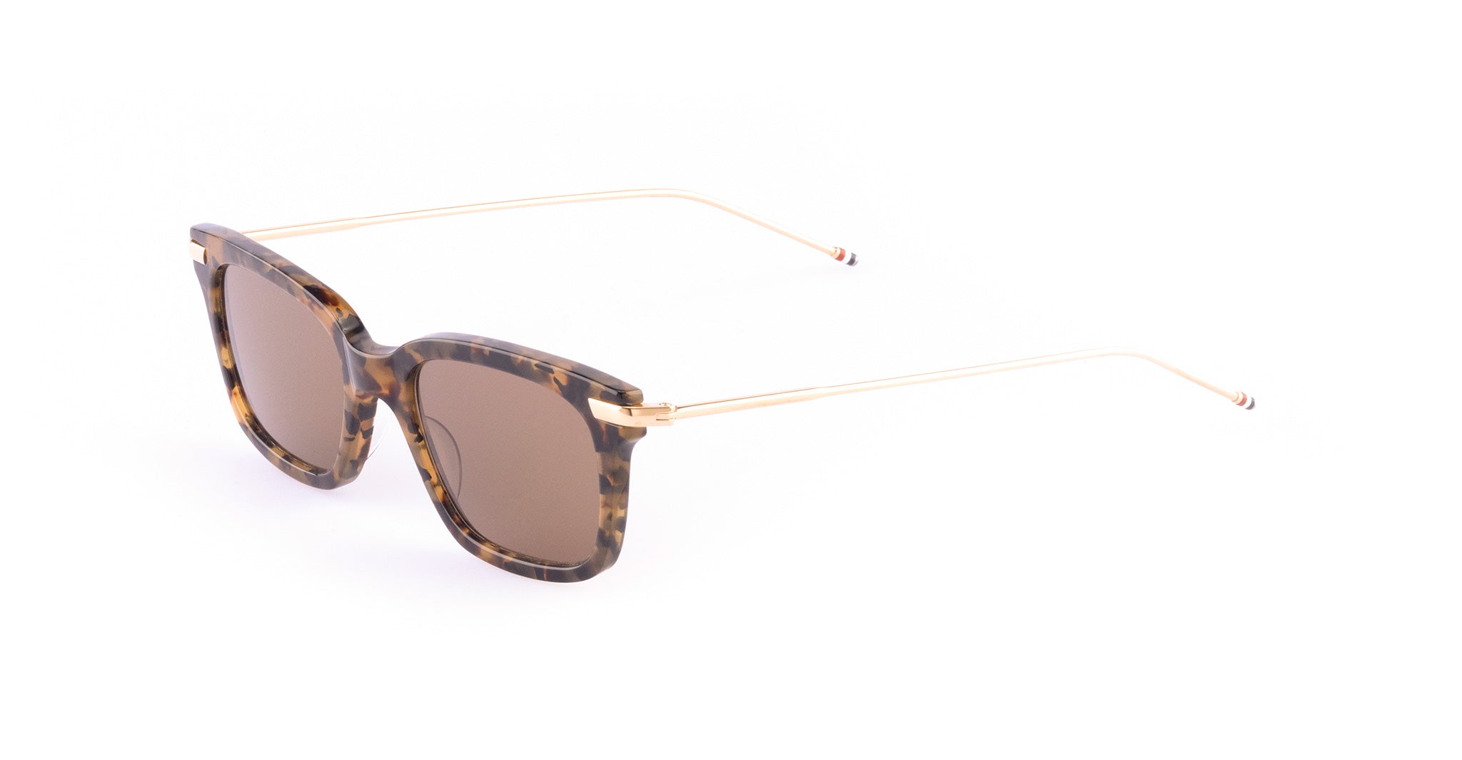 Thom Browne 701 sunglasses with square tortoiseshell frame, brown lenses, and thin gold-tone arms, shown from a side angle.
