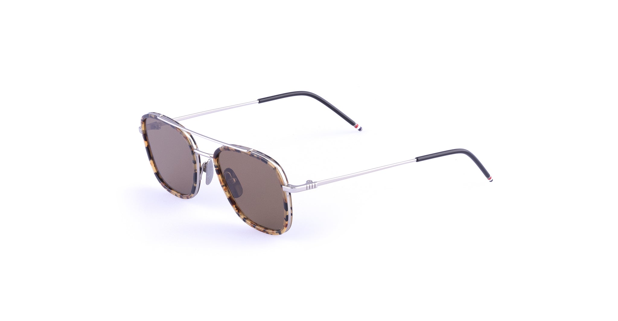 A pair of Thom Browne 800 Sunglasses in Brown Tortoise featuring aviator-style dark lenses, thin silver metal arms, and tortoiseshell-patterned rims. The black-tipped arms are accented with subtle red and white details.
