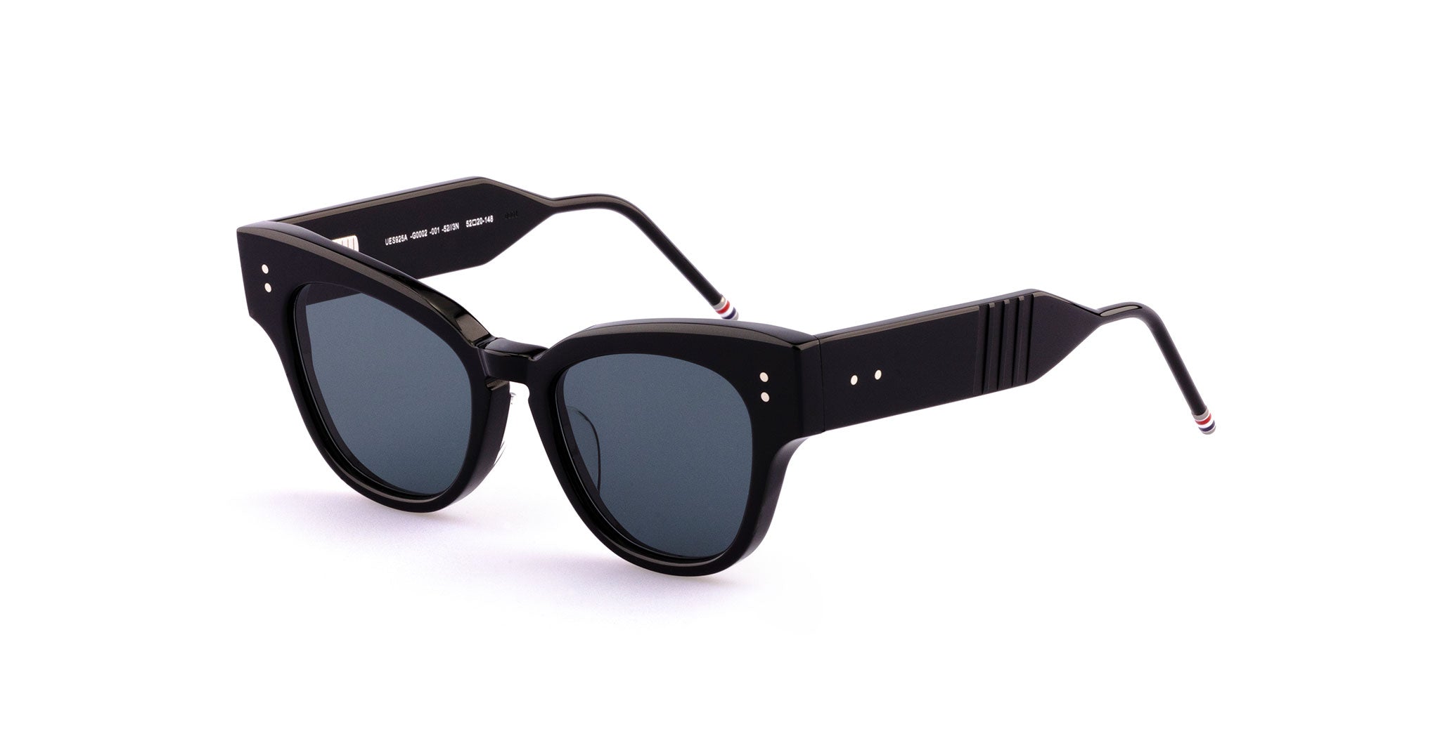 Thom Browne 925 sunglasses: black round frames, dark lenses, silver rivets. Front view of bold silhouette eyewear by Thom Browne.
