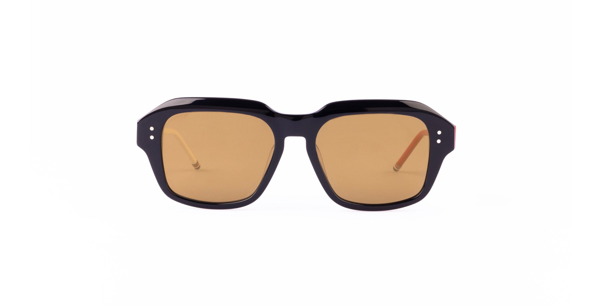 A pair of Thom Browne 928 sunglasses with thick, black geometric navy frames and brown-tinted lenses is shown against a plain white background.