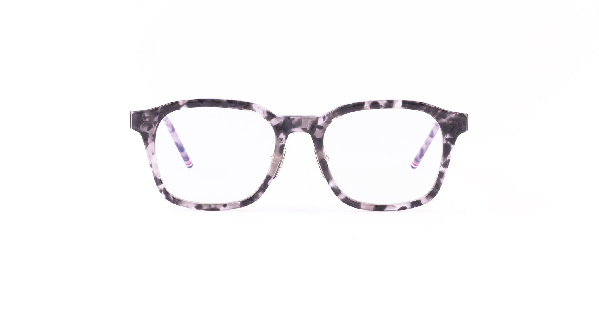 A pair of rectangular Thom Browne eyeglasses with a gray and black marbled pattern.