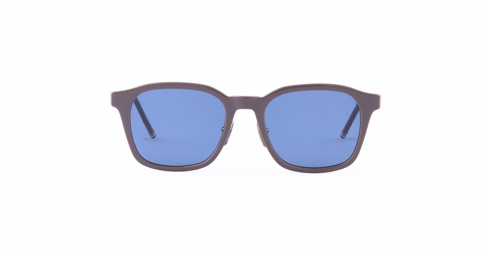 A pair of sunglasses with thick, dark frames and blue-tinted square lenses, shown from the front.