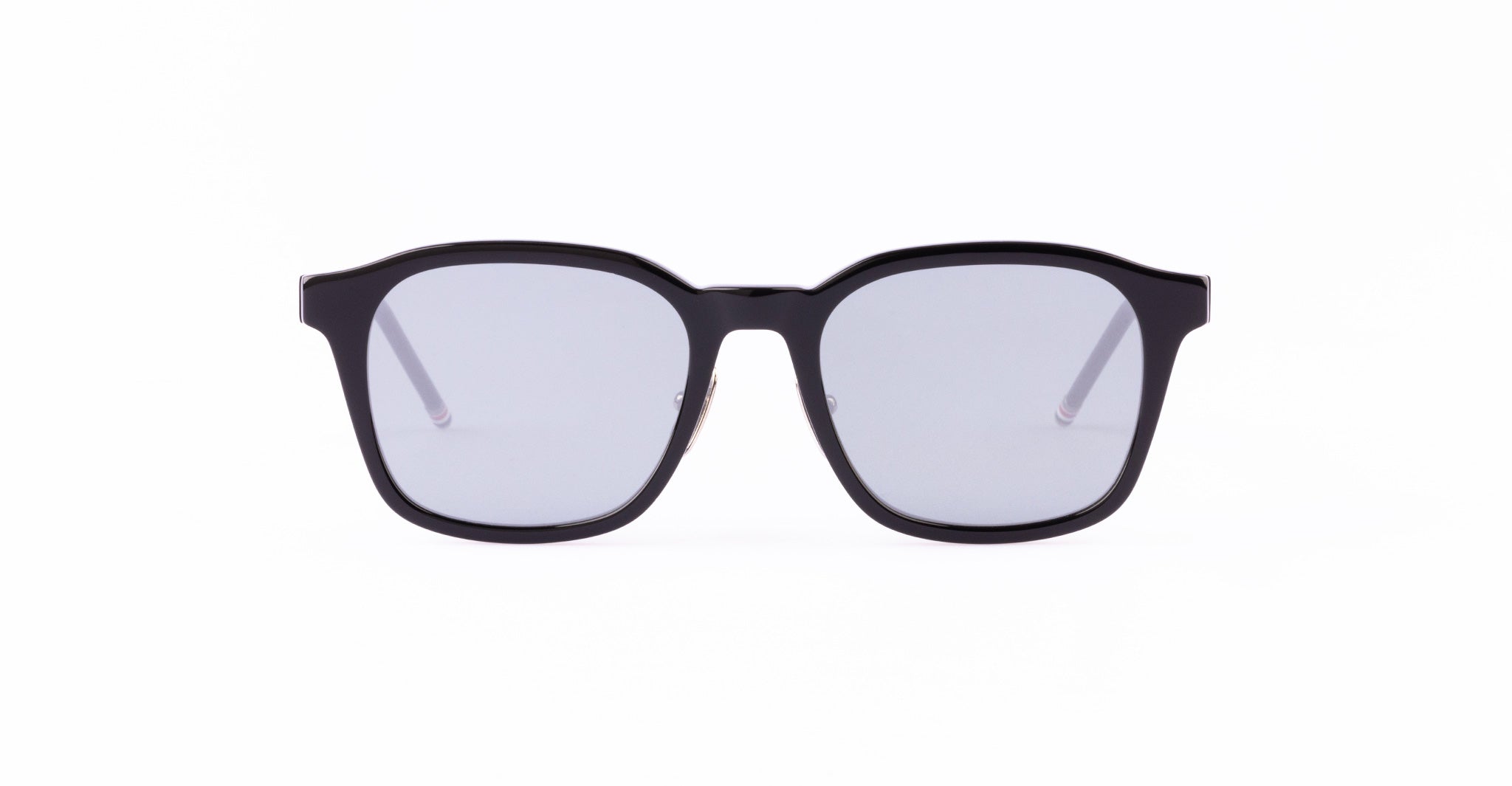 A pair of black, square-shaped Thom Browne Sunglasses with dark lenses.
