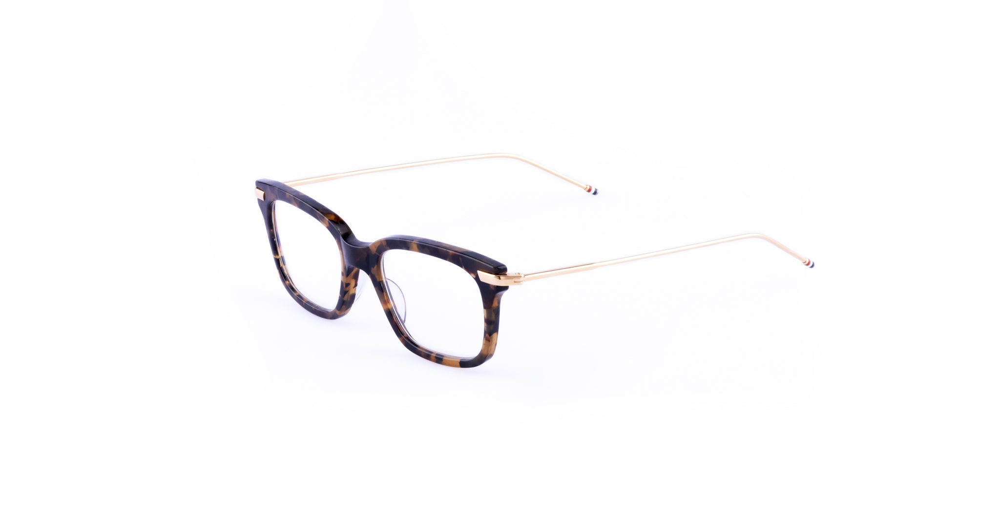 Thom Browne 701 eyeglasses feature a classic rectangular tortoiseshell frame with thin gold metal arms, shown from the front angle.