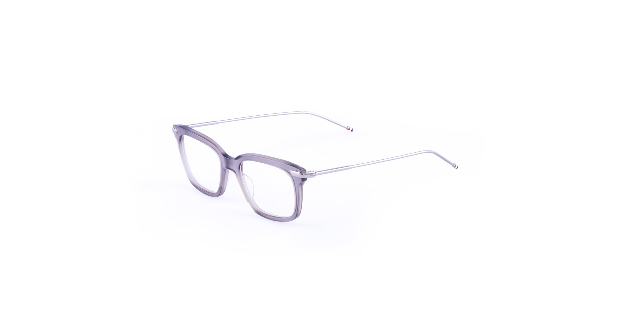 Thom Browne 701 eyeglasses with clear rectangular frames and slim silver metal arms, shown from a three-quarter front angle.