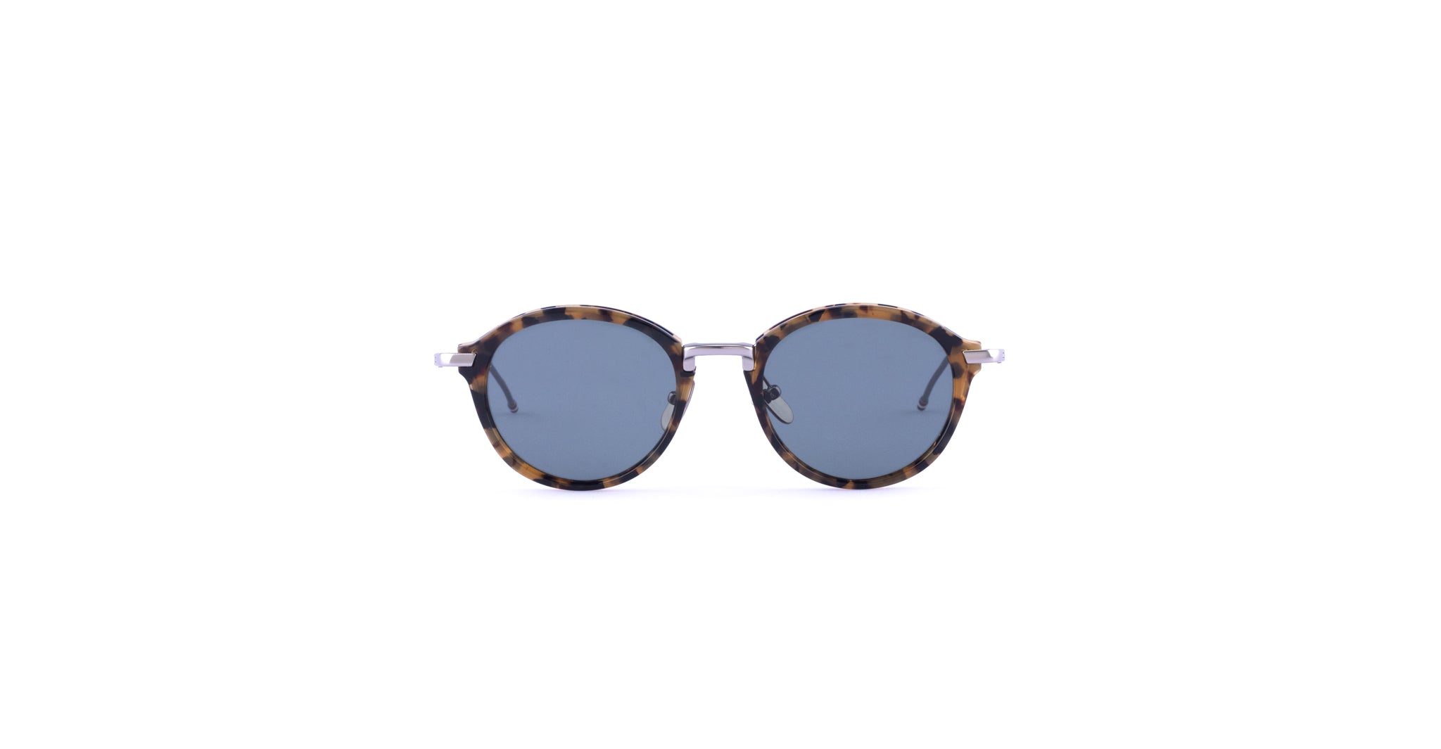 Thom Browne 011 round sunglasses featuring dark blue lenses and tortoiseshell-patterned frames, displayed against a plain white background.