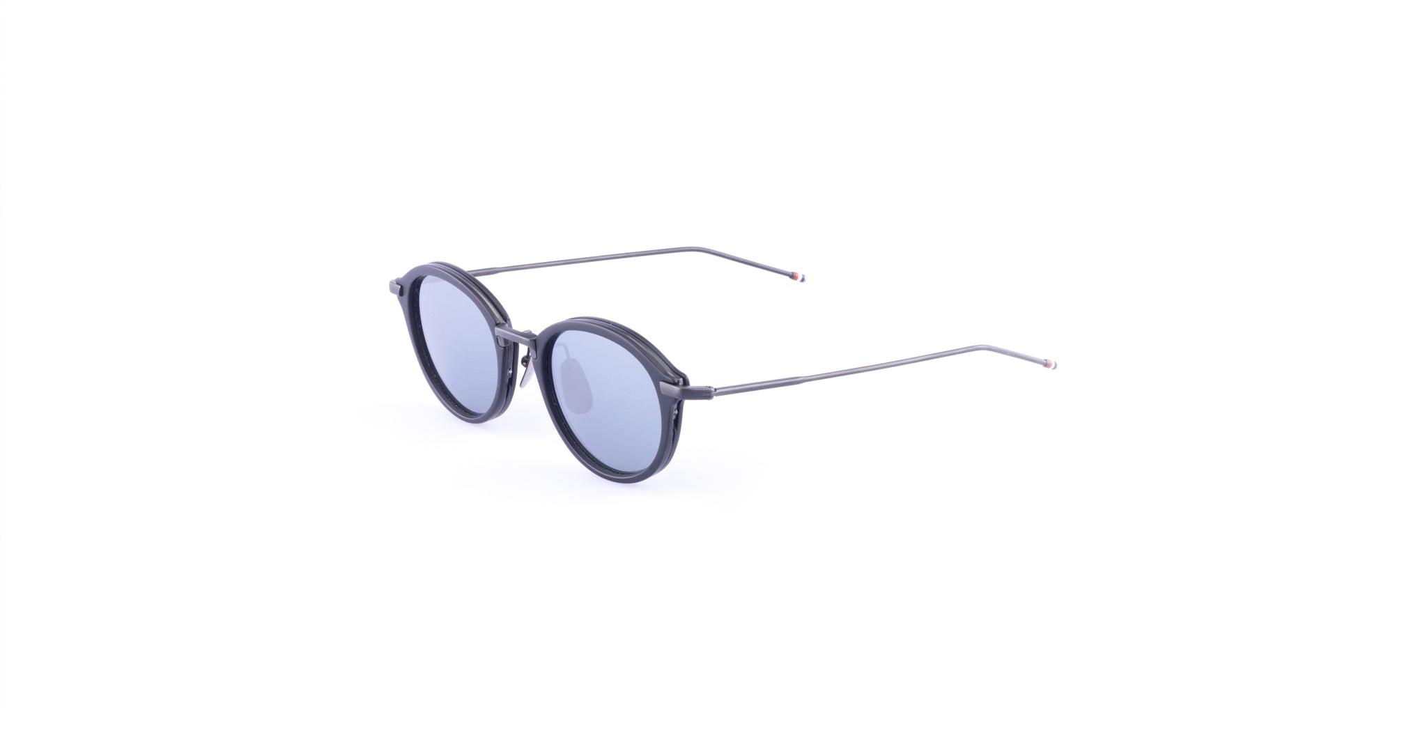 Thom Browne 011 round sunglasses with thin black frames and blue-tinted lenses, shown on a white background at a slight angle.