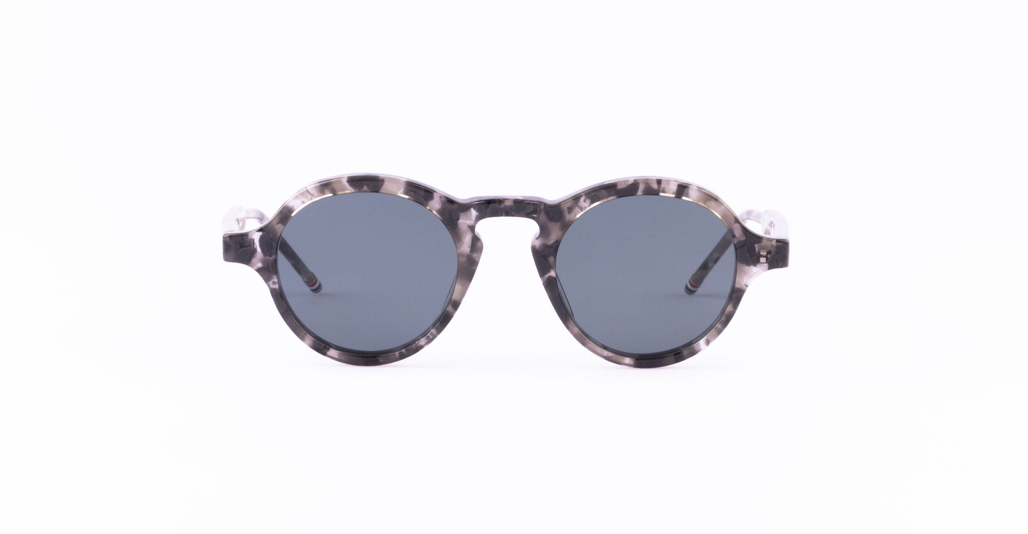 Thom Browne 926 round sunglasses with dark lenses and a marbled gray and black patterned frame, displayed on a plain white background.