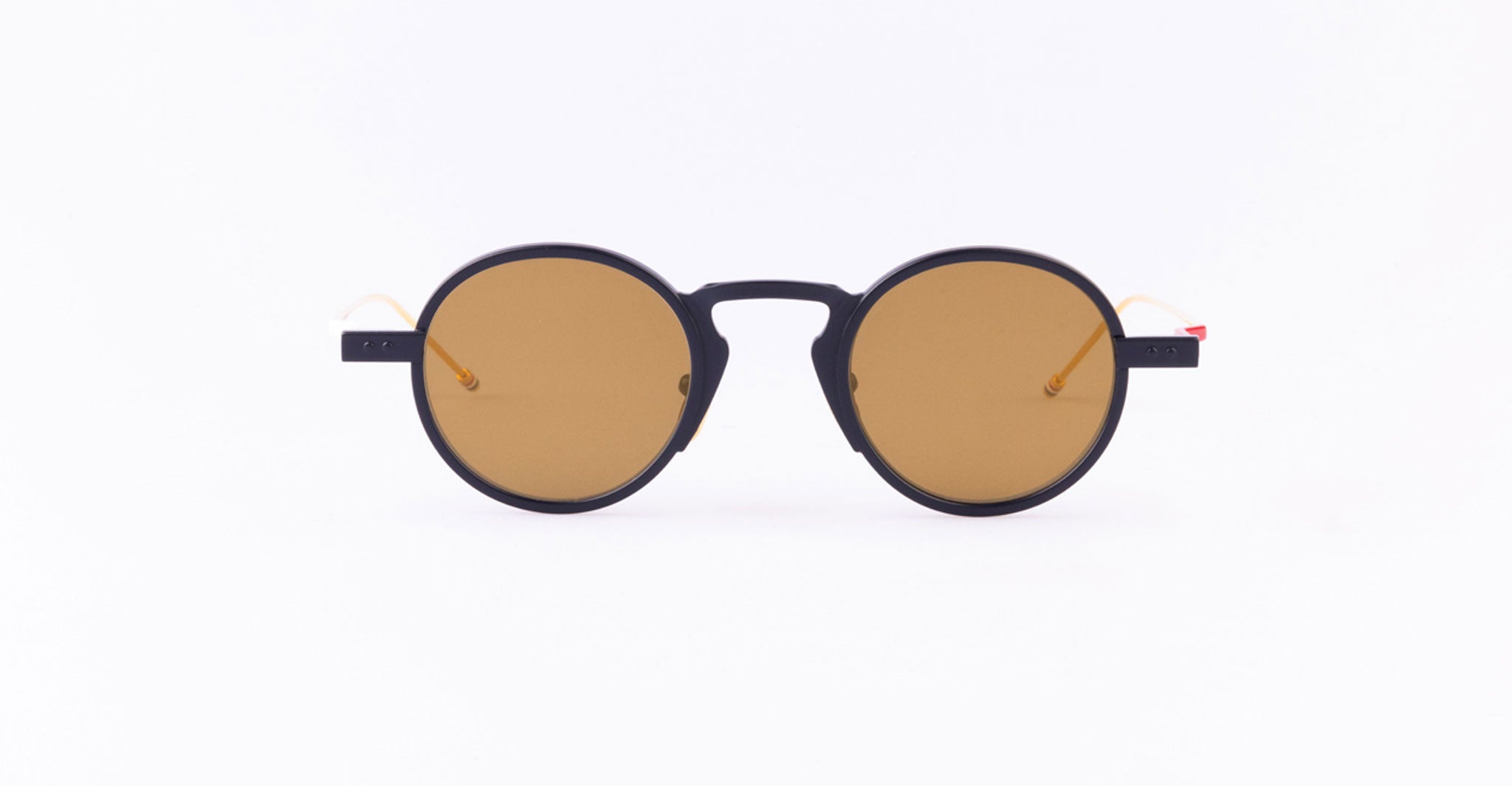 Thom Browne 931 round sunglasses, navy blue frames, brown-tinted lenses, front view.