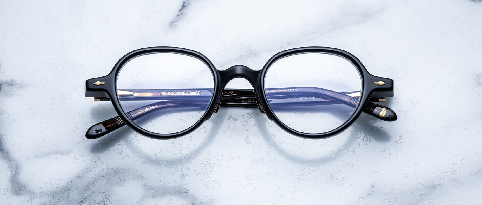 Jacques Marie Mage The Clark round black eyeglasses with blue-tinted lenses, top view.